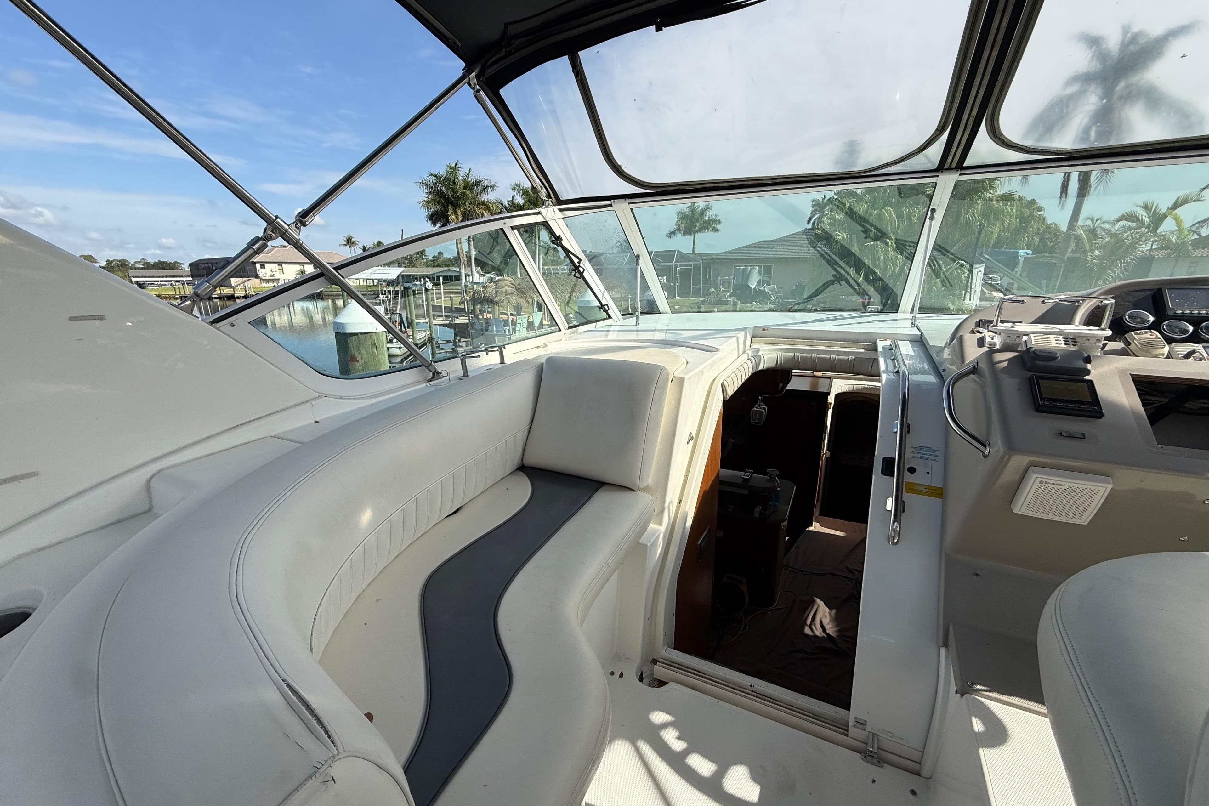 2002 Cruisers Yachts 4450 Express Motoryacht cockpit with seating and helm, dockside view.