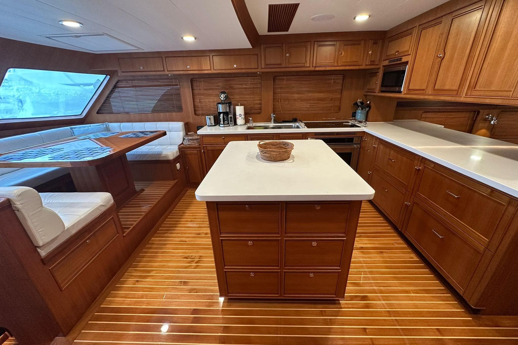 Luxurious 2023 Marlow Explorer 66E-CB yacht kitchen with wood cabinetry and modern amenities.