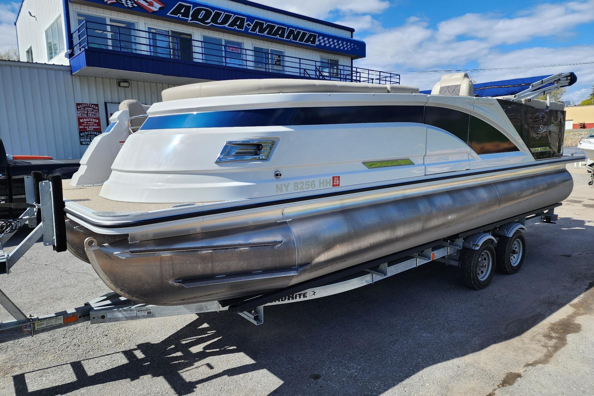 2022 Silver Wave 2410 SW5 pontoon boat on trailer at Aqua-Mania dealership.
