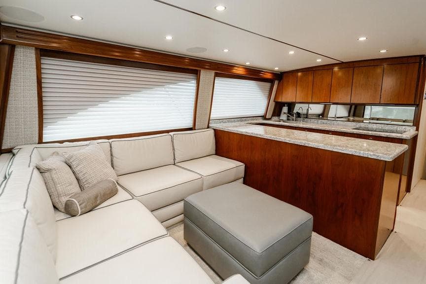 Luxurious interior of 2021 Viking 58 Convertible yacht with modern kitchen and cozy seating area.