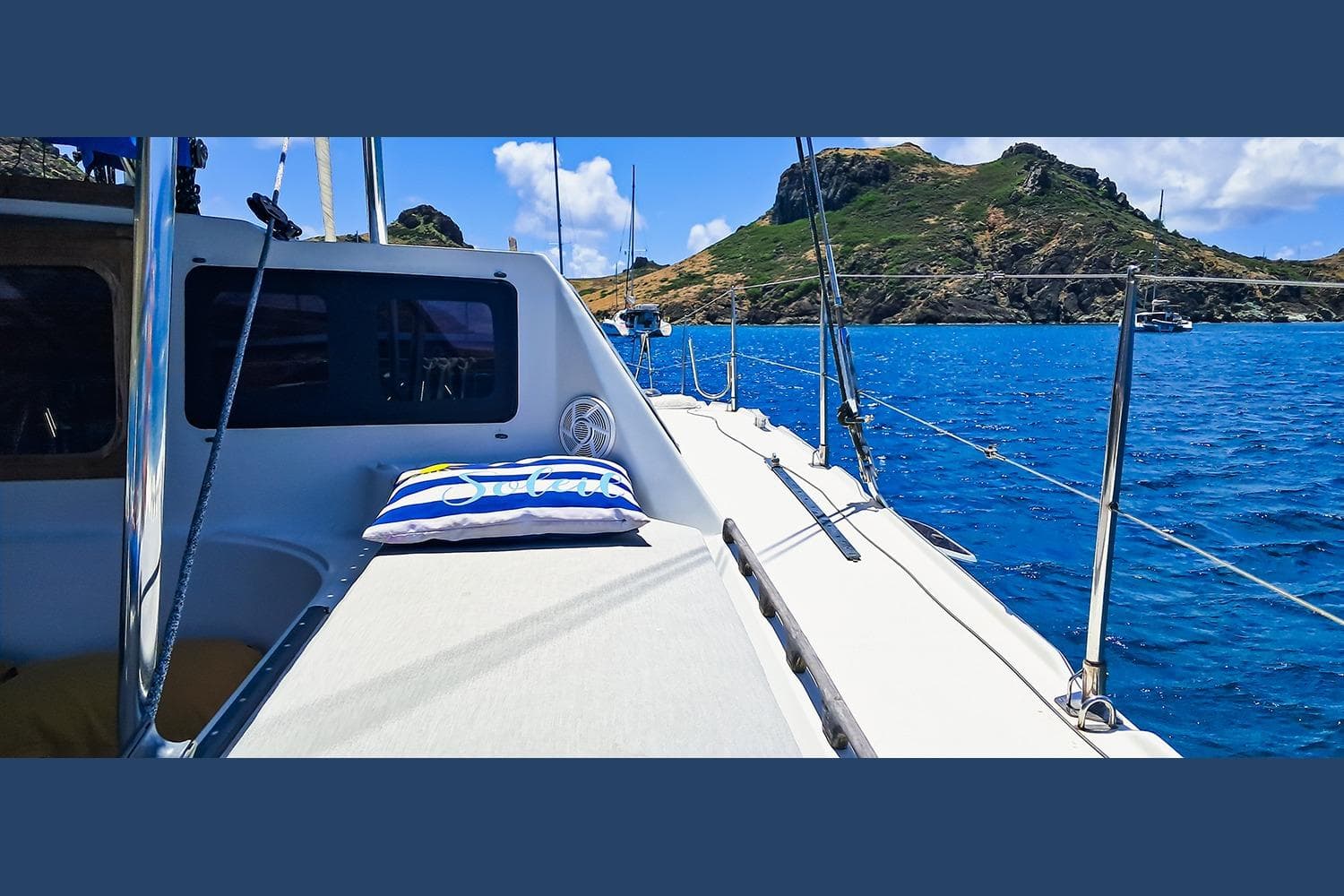 Sailing yacht Privilege 39, 1992 model, anchored near scenic island coastline.