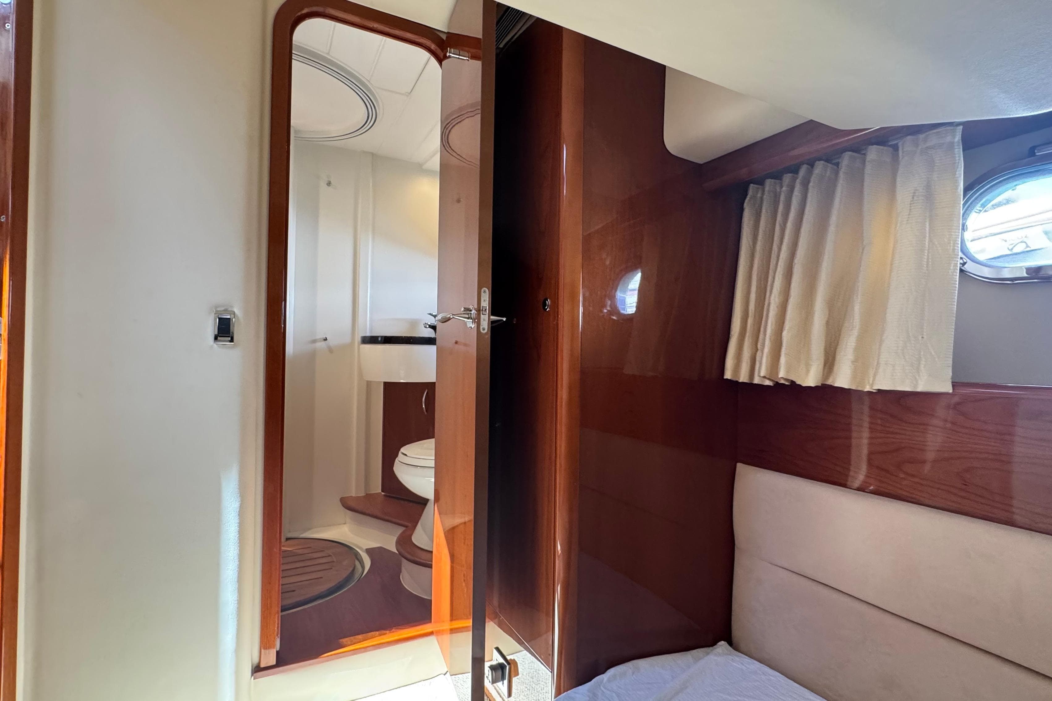 Interior of 2006 Princess 42 Flybridge Motor Yacht with bathroom and wooden finishes.