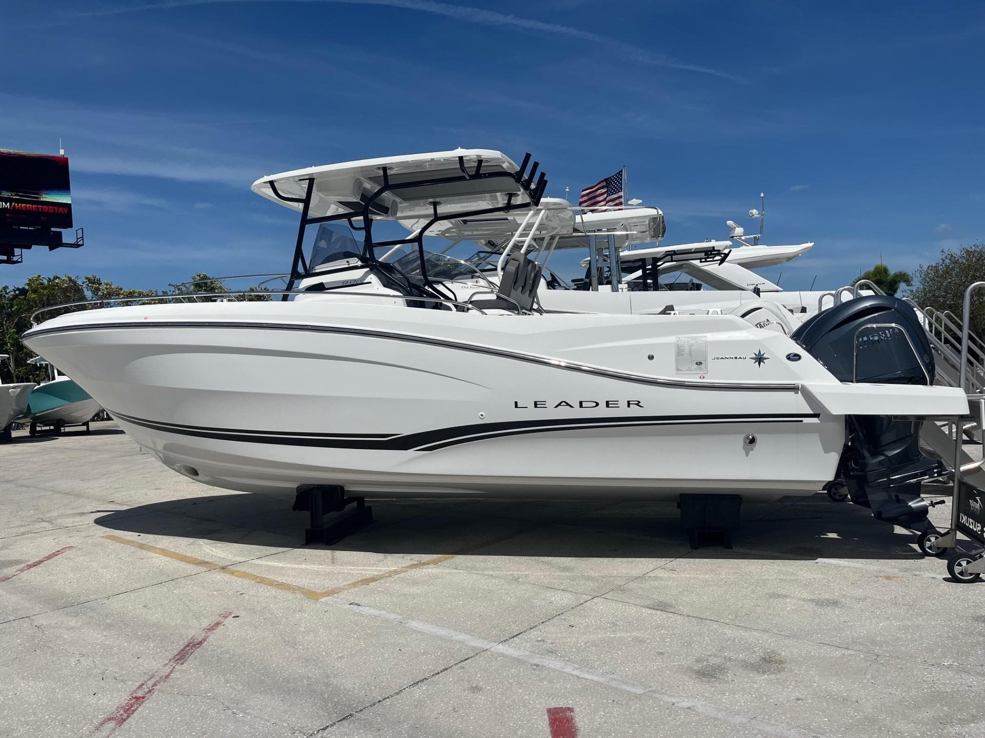2024 Jeanneau Leader 9.0 CC boat on display under clear blue sky.