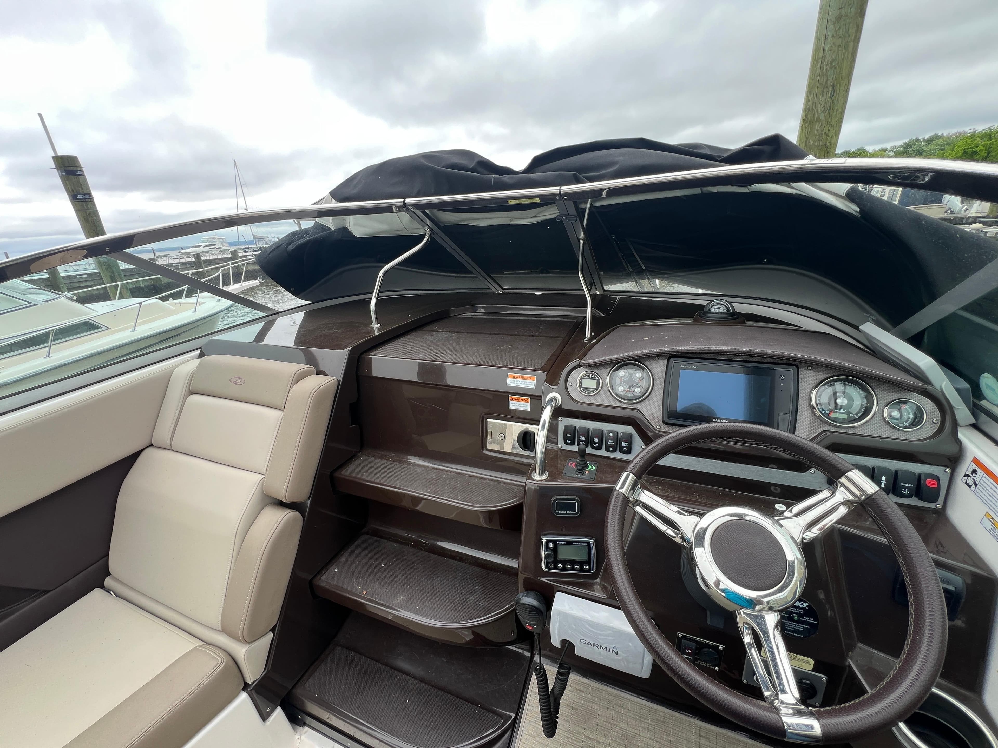 2015 Regal 28 Express boat cockpit with steering wheel and control panel.