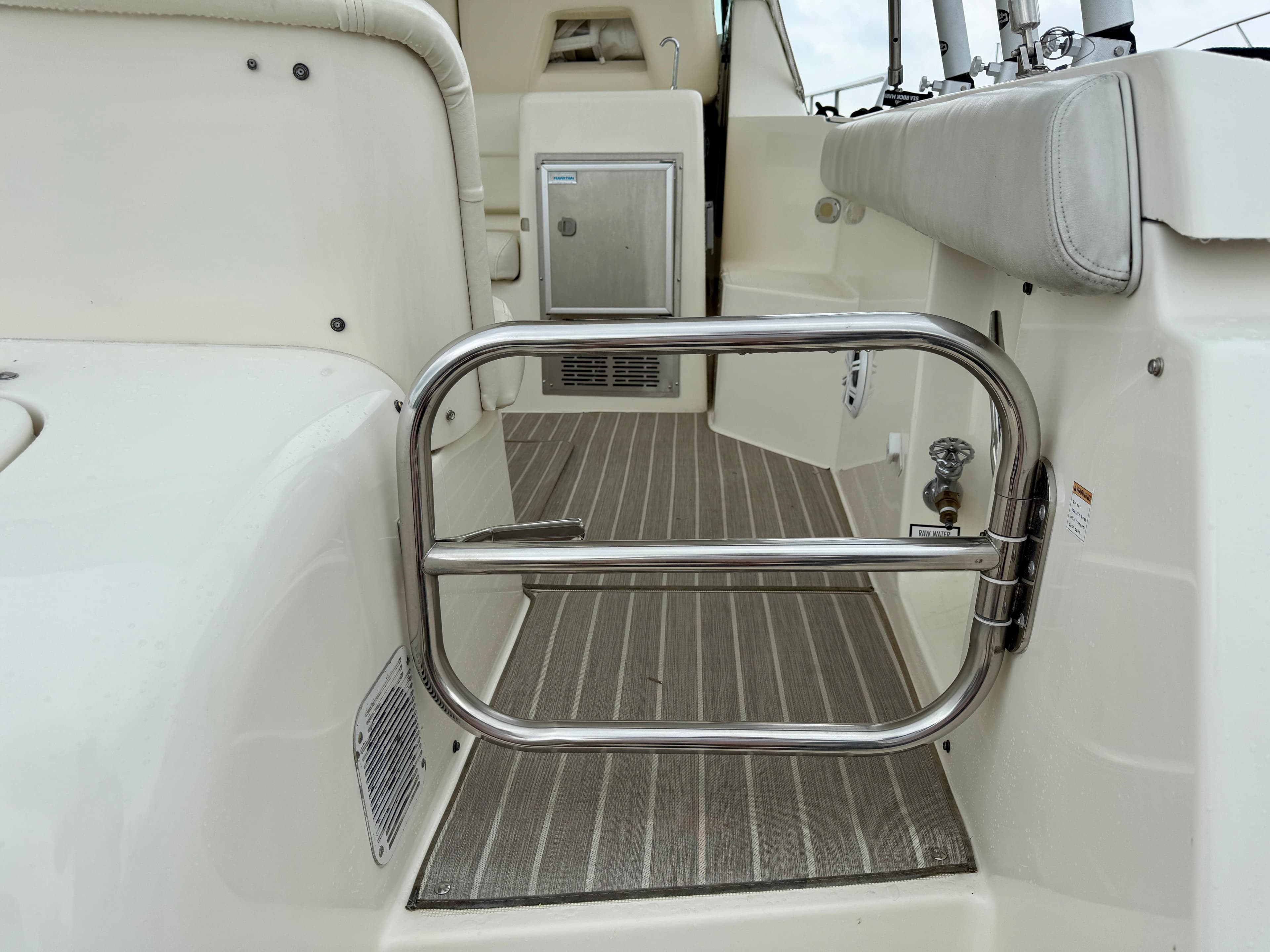 2004 Tiara Yachts 4000 Express interior with stainless steel gate and cushioned seating.