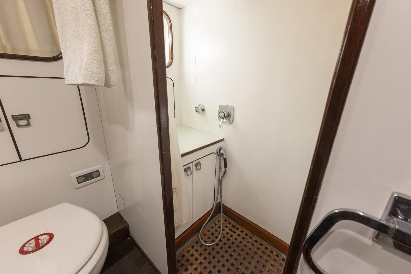 Bathroom interior of 1982 Benetti Sail Division 16m Motorsailer, featuring shower and toilet.