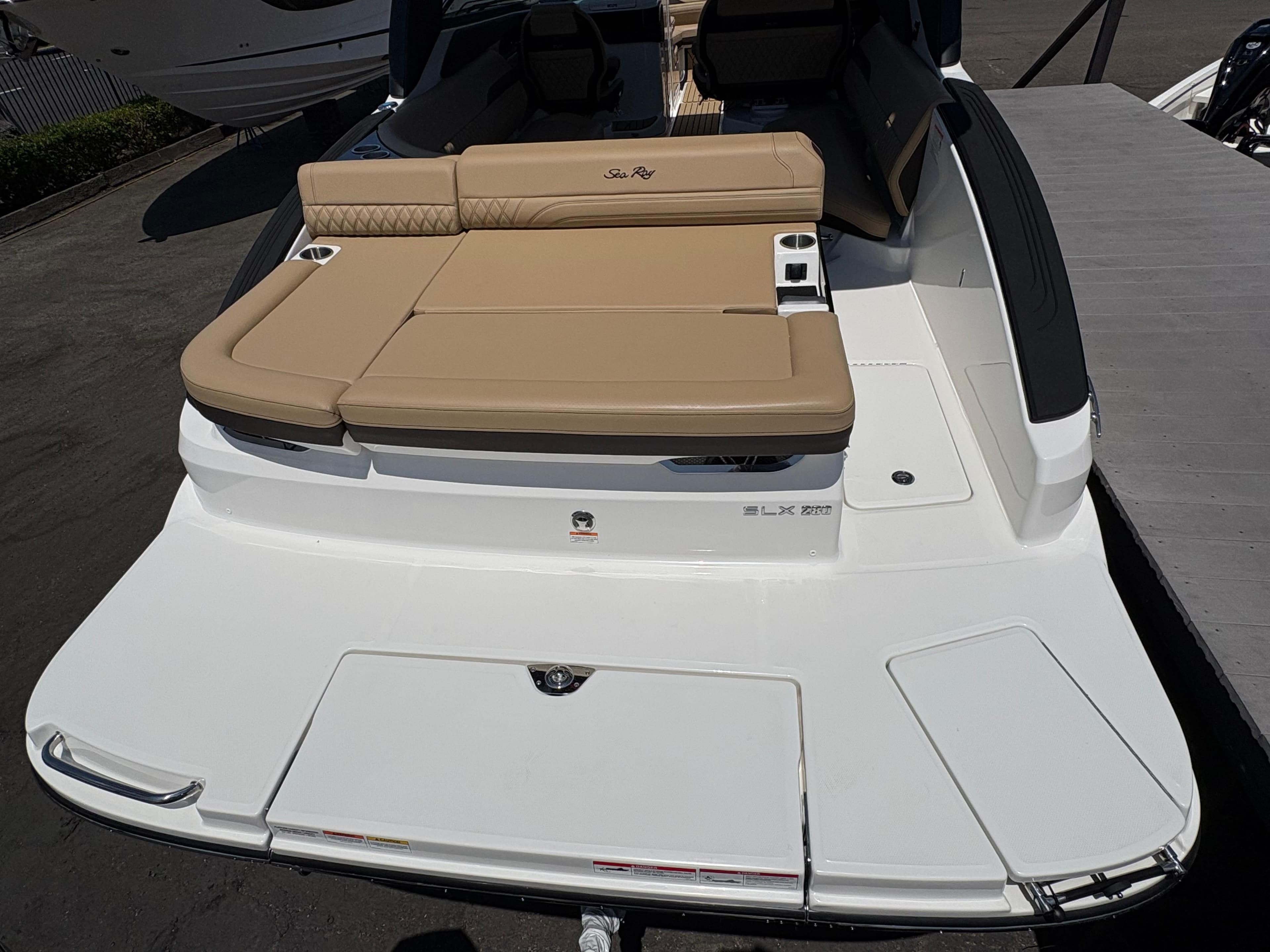 2026 Sea Ray SLX 280 boat with tan seating and sleek white deck.
