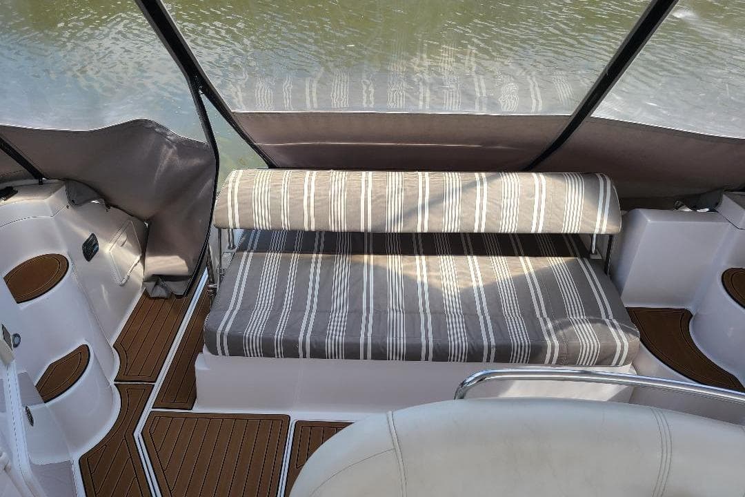 2009 Regal Commodore 3760 IB interior with striped seating and wooden flooring.