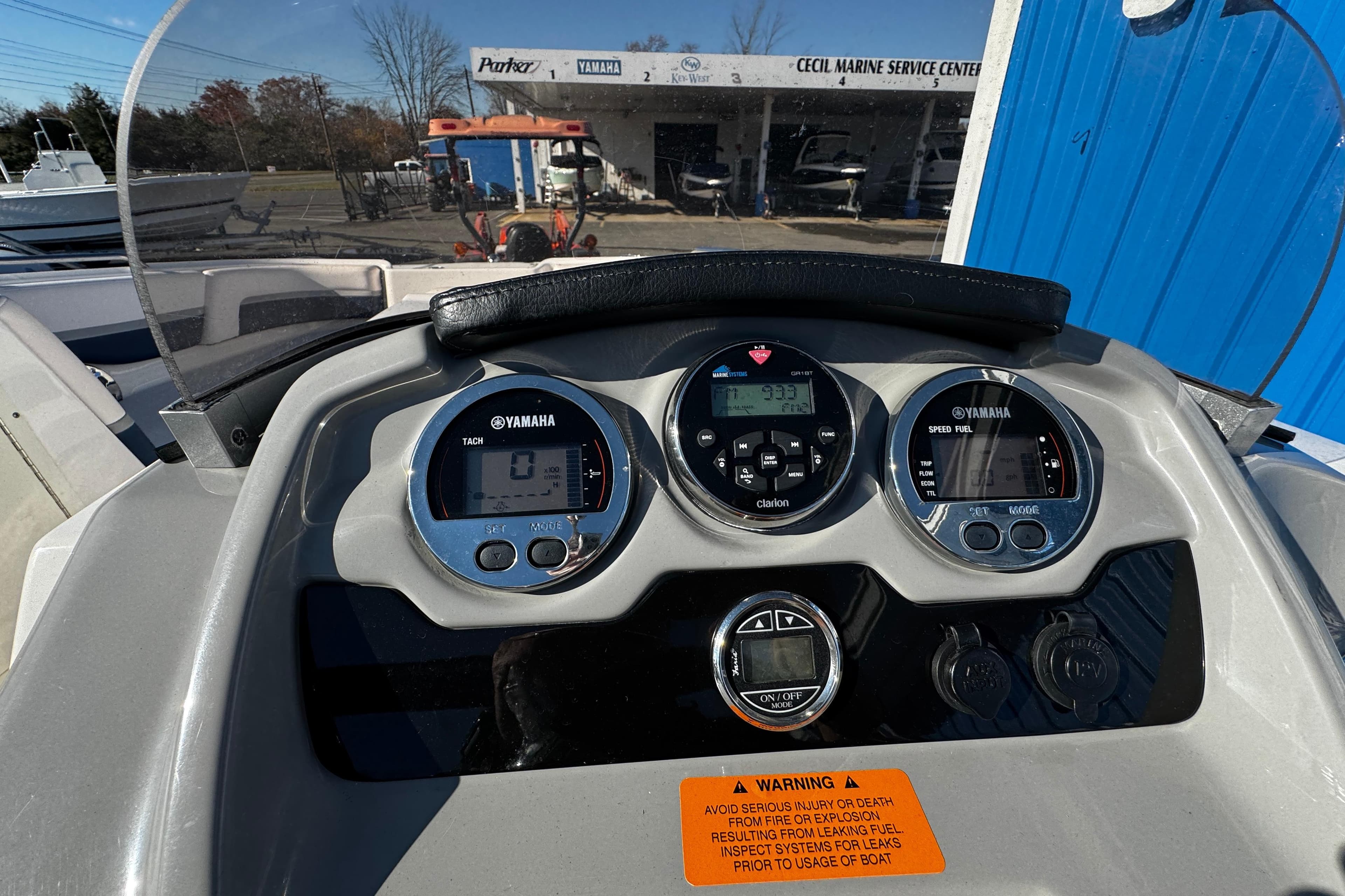 Dashboard of 2019 Chaparral 191 Suncoast boat with Yamaha gauges and warning label.