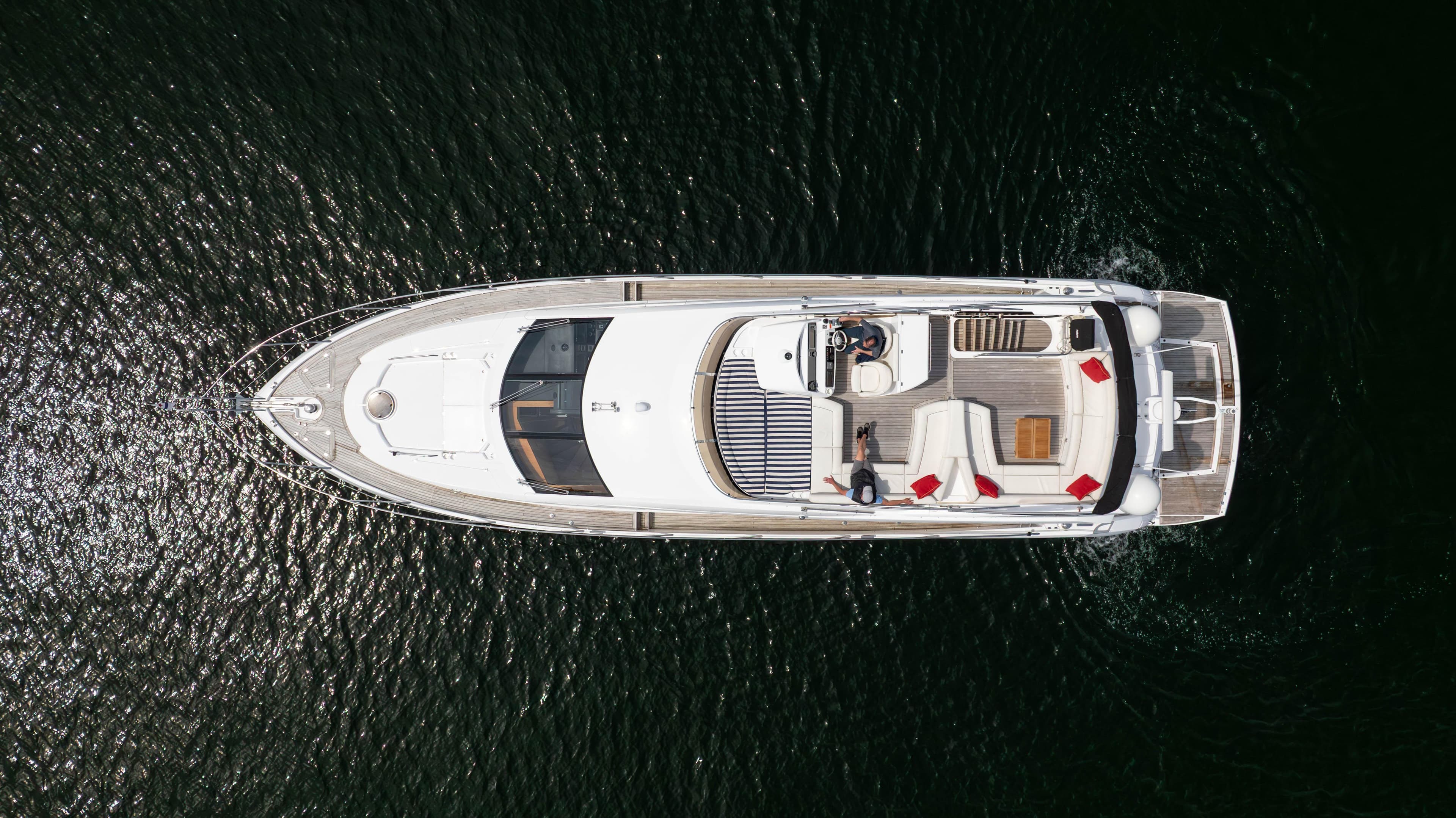 Aerial view of 2012 Sunseeker Manhattan 63 yacht on dark water.