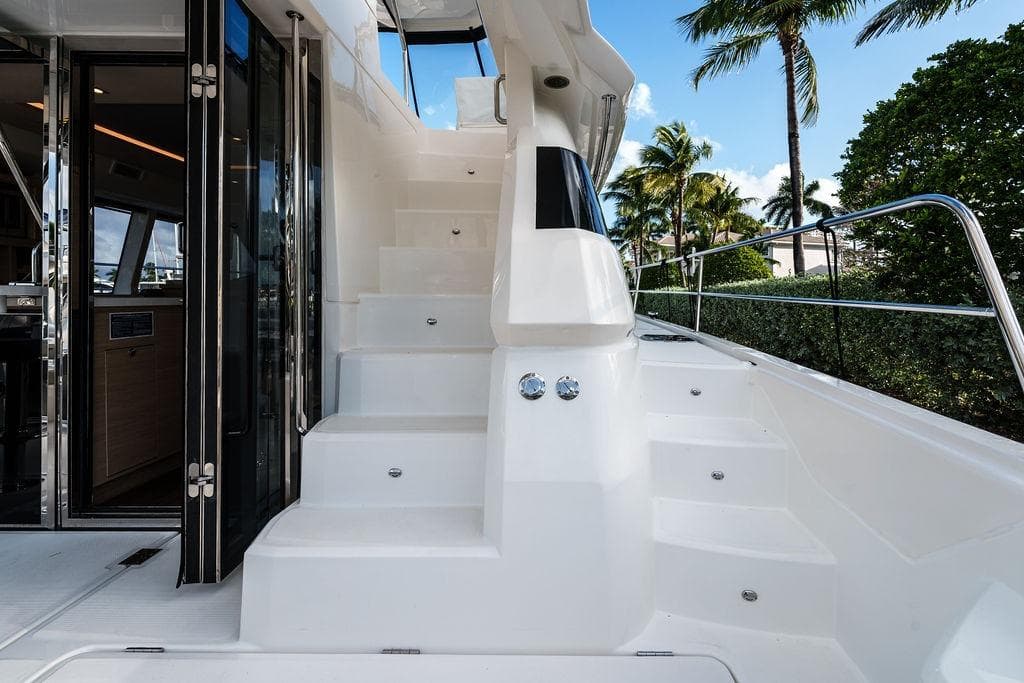 2023 Aquila 44 Yacht with sleek white stairs and modern interior design.