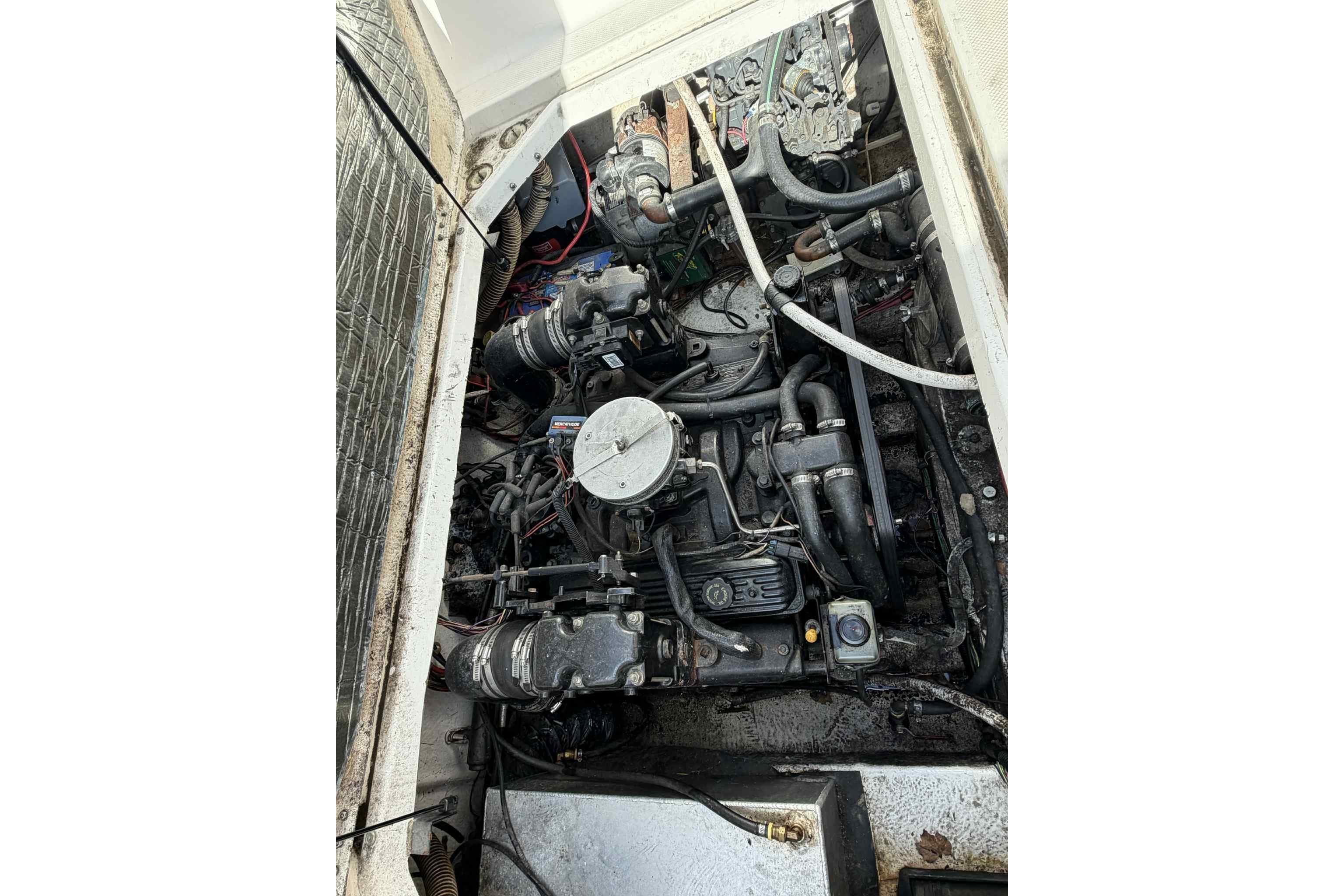 Engine compartment of a 1999 Bayliner 2655 Ciera boat, showing mechanical components.