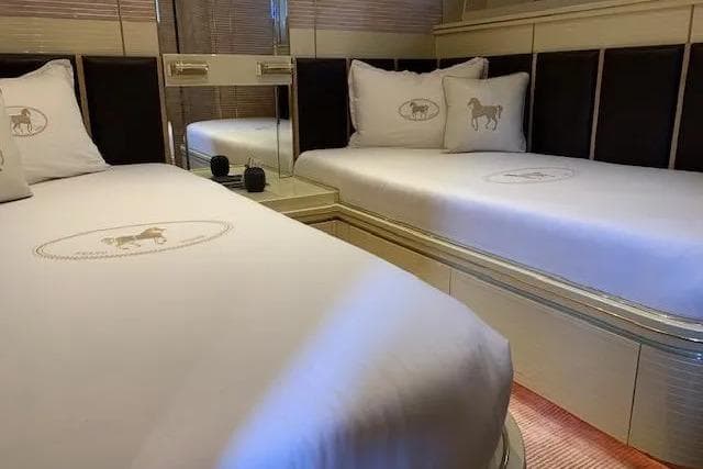 Luxurious twin cabin on 1995 Mondomarine 30 yacht with elegant bedding.