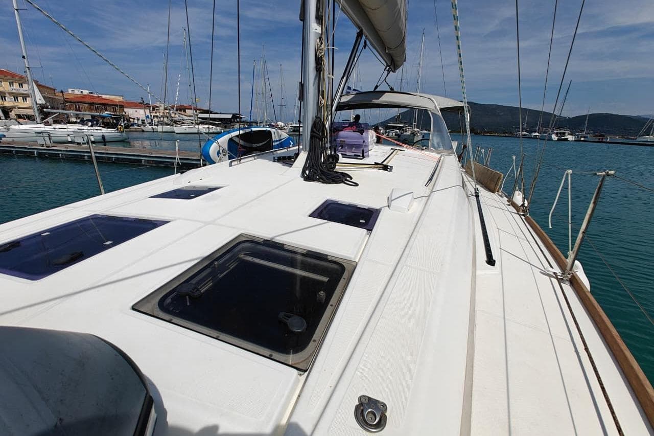 2016 Beneteau Oceanis 45 sailboat docked in a marina, clear sky, calm waters.