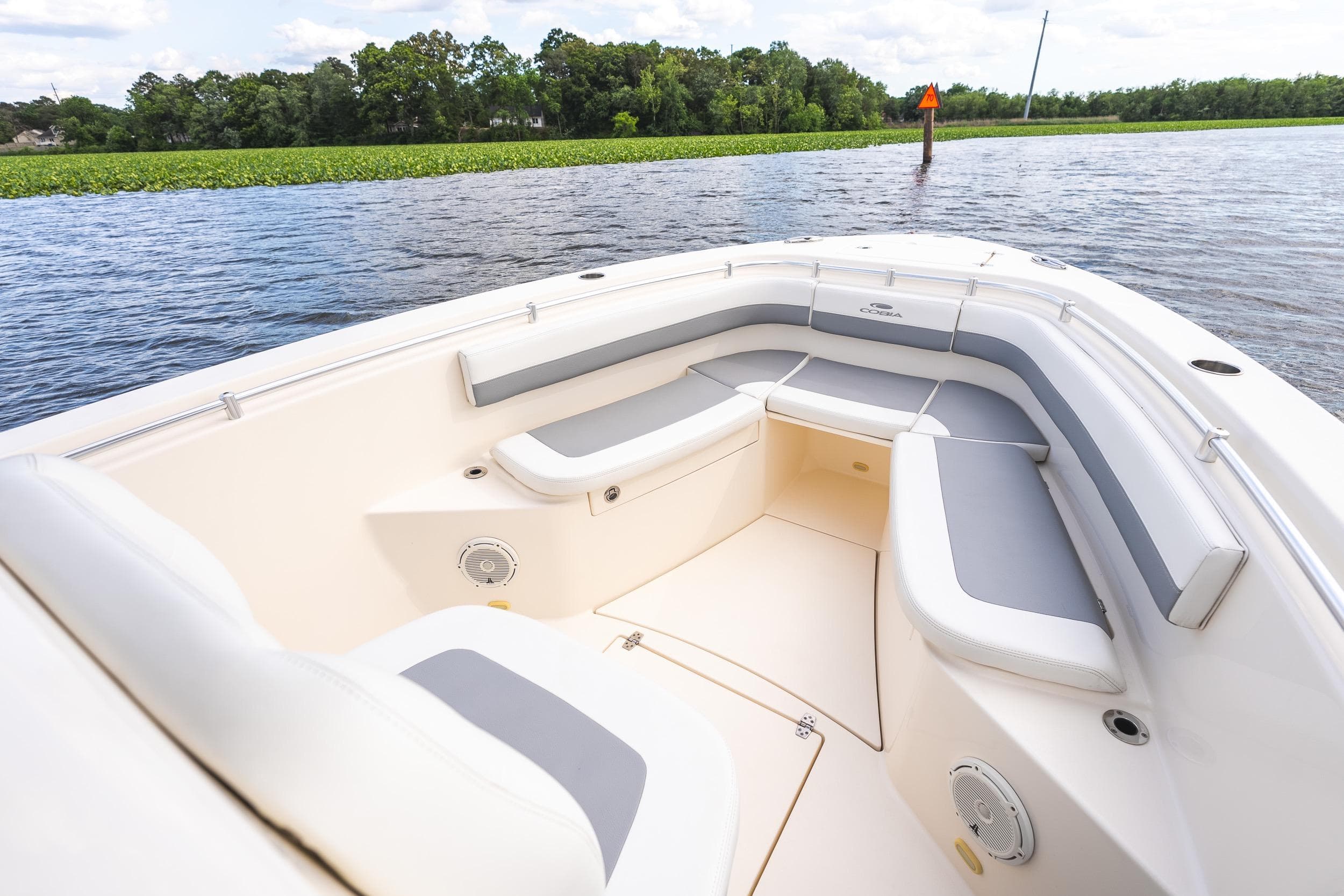 2019 Cobia 277 Center Console boat with spacious seating on calm water.