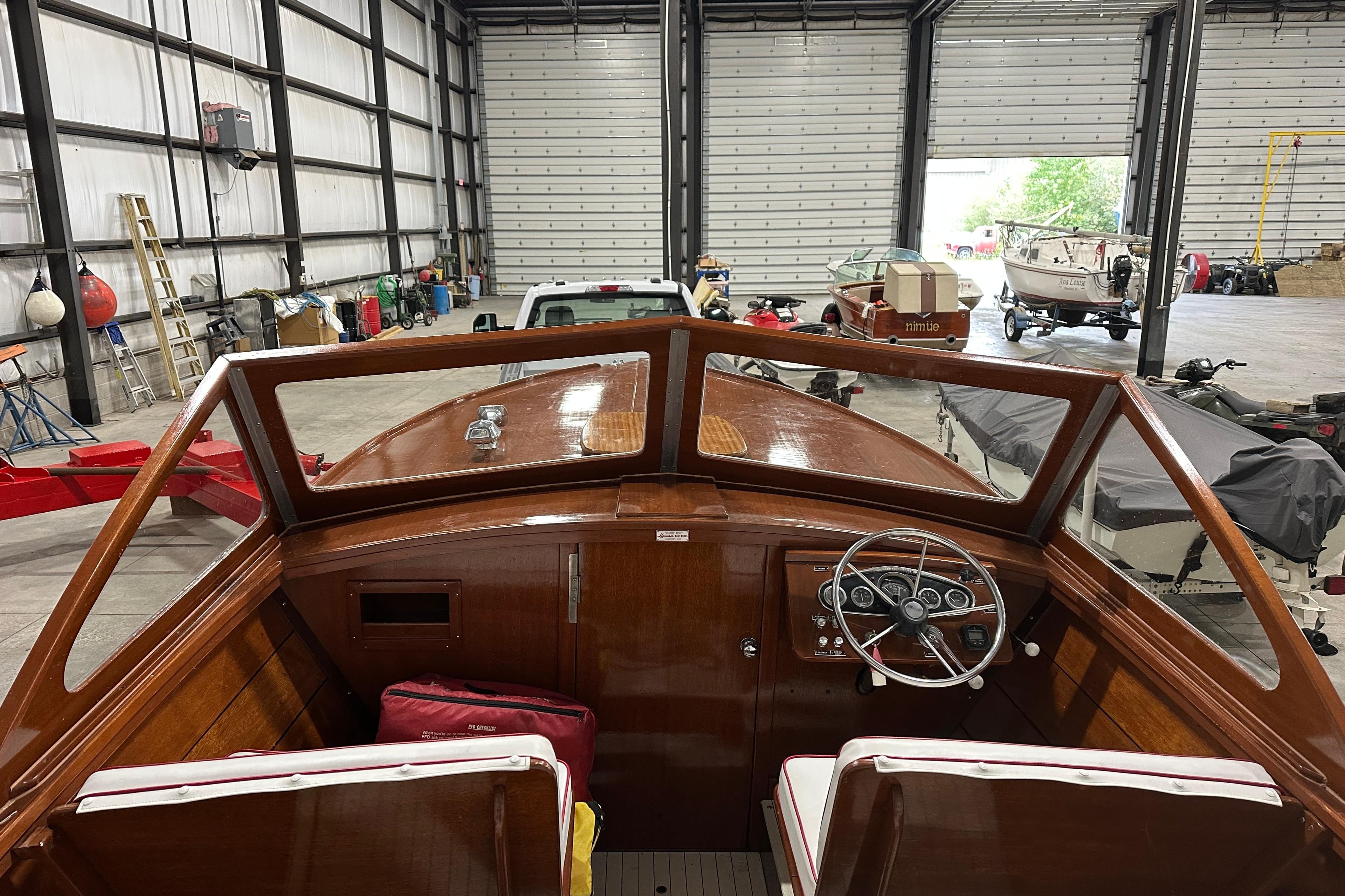 1961 Lyman 21 Runabout boat interior in a spacious garage setting.