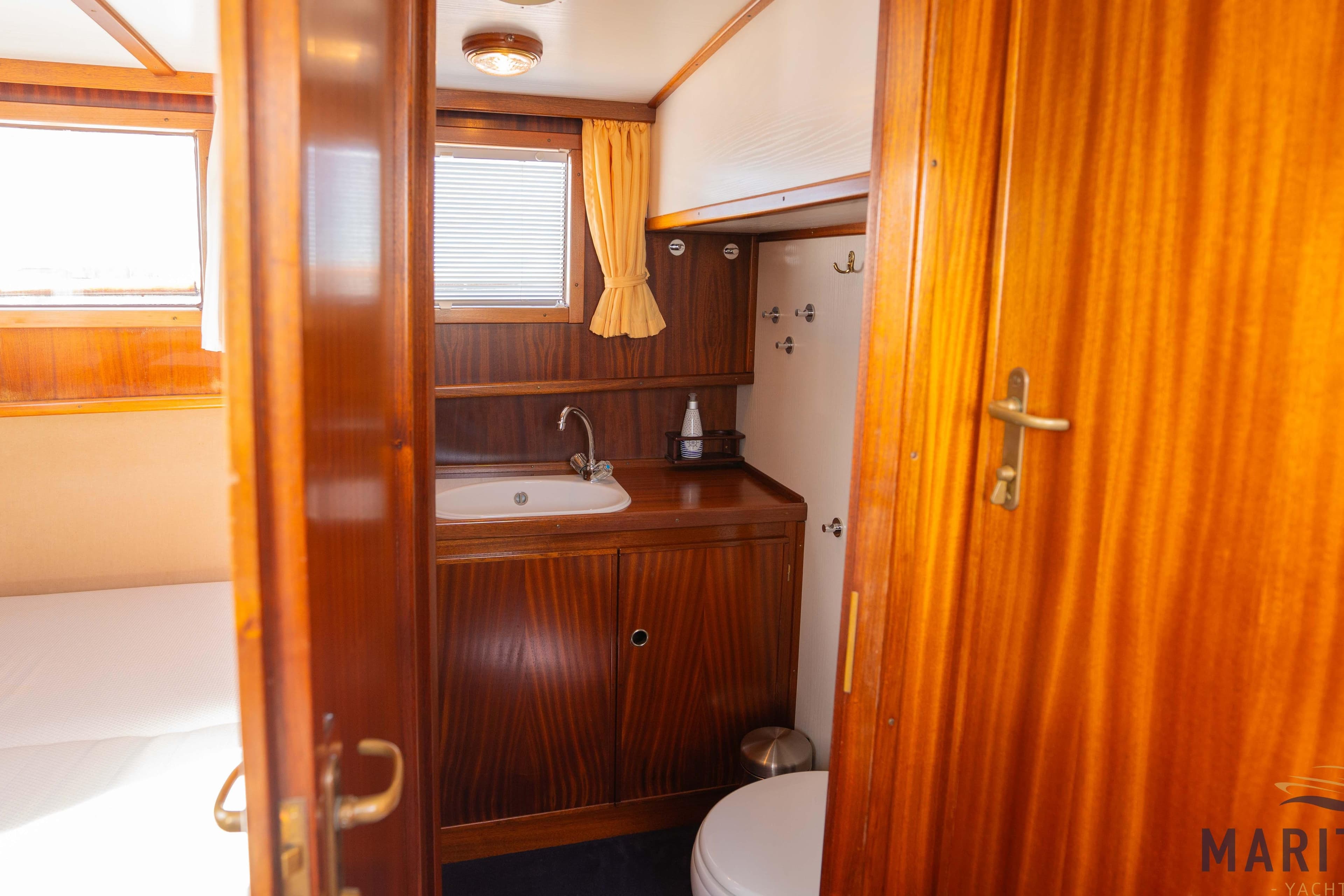 Elbtrawler 1095 yacht bathroom with wooden cabinetry and sink, 1996 model.
