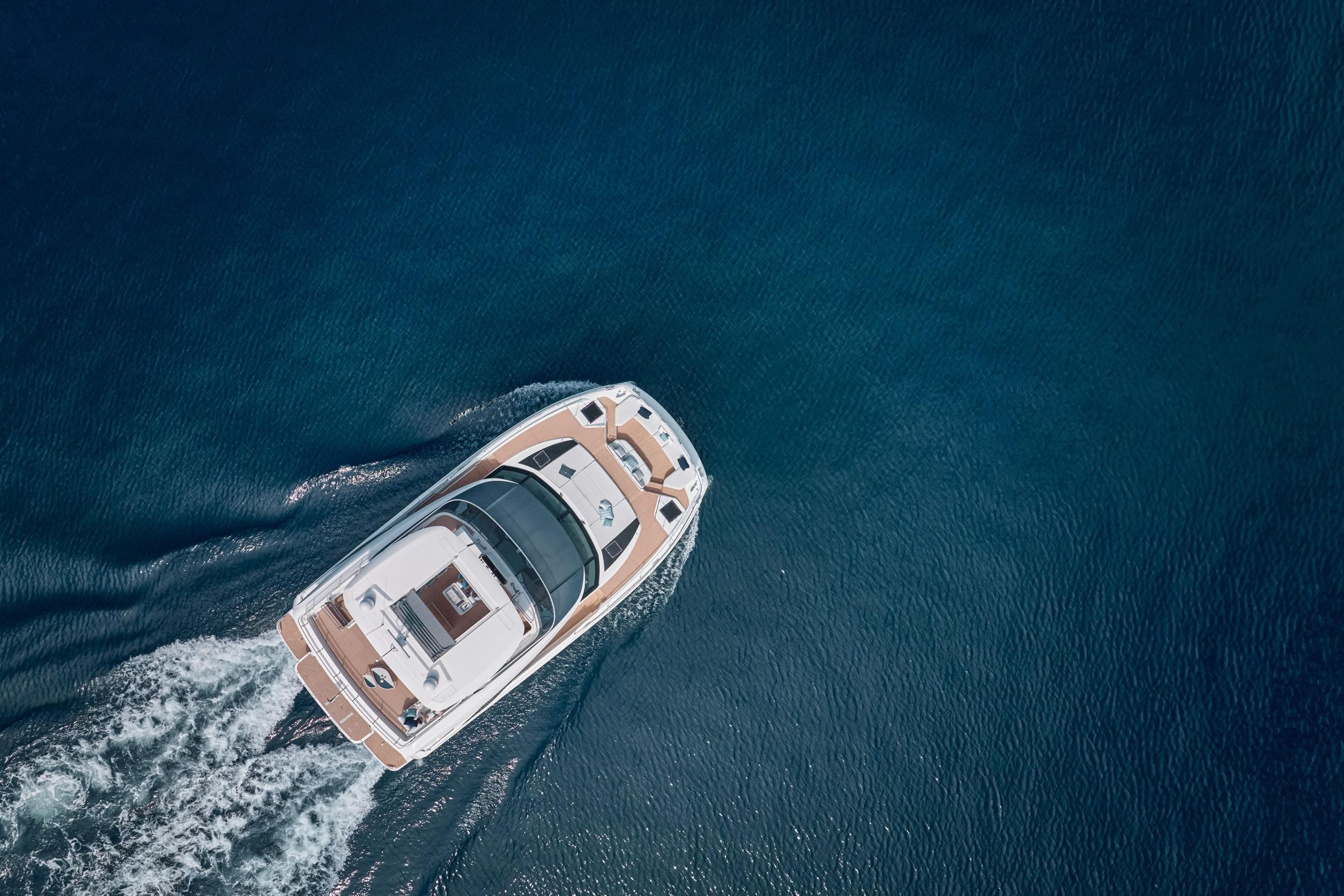 Aerial view of 2026 Prestige M8 yacht cruising on open blue water.