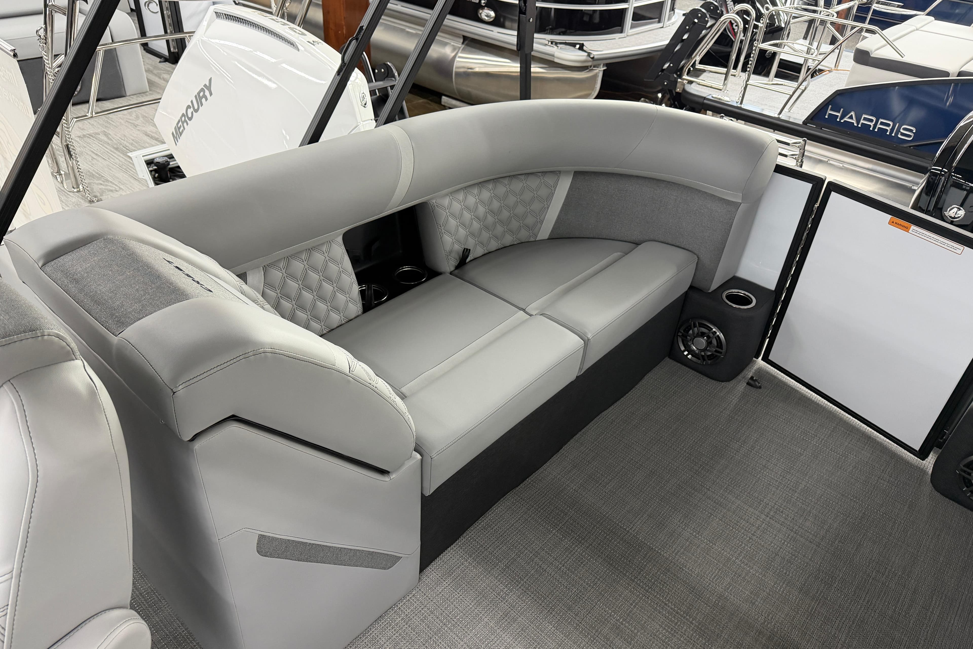 Luxurious seating on the 2026 Crest Conquest 210 SLC pontoon boat, featuring elegant gray upholstery.