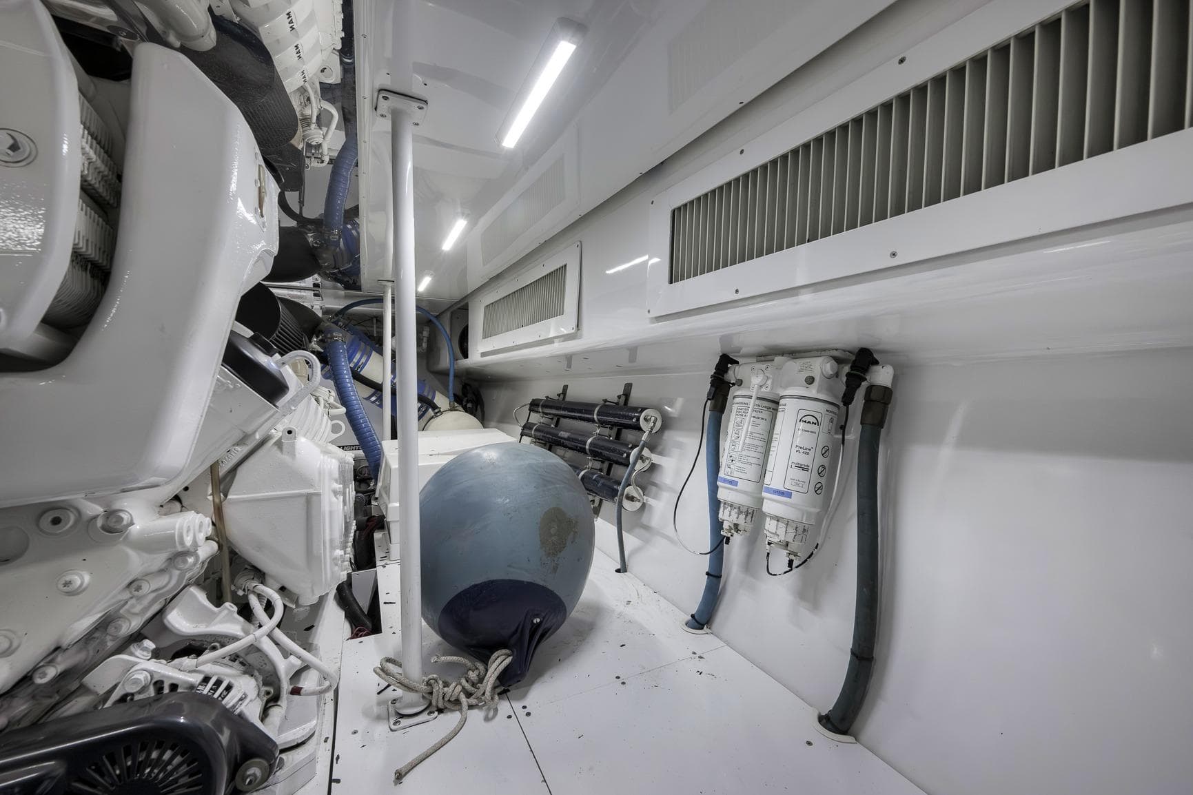 Engine room of 1999 Hines-Farley SPORTFISHERMAN with mechanical components and equipment.