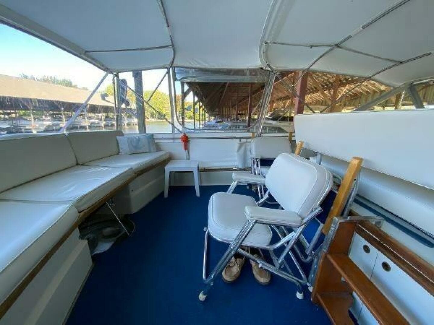 1970 Chris-Craft 42 Commander interior with white seating and blue flooring.