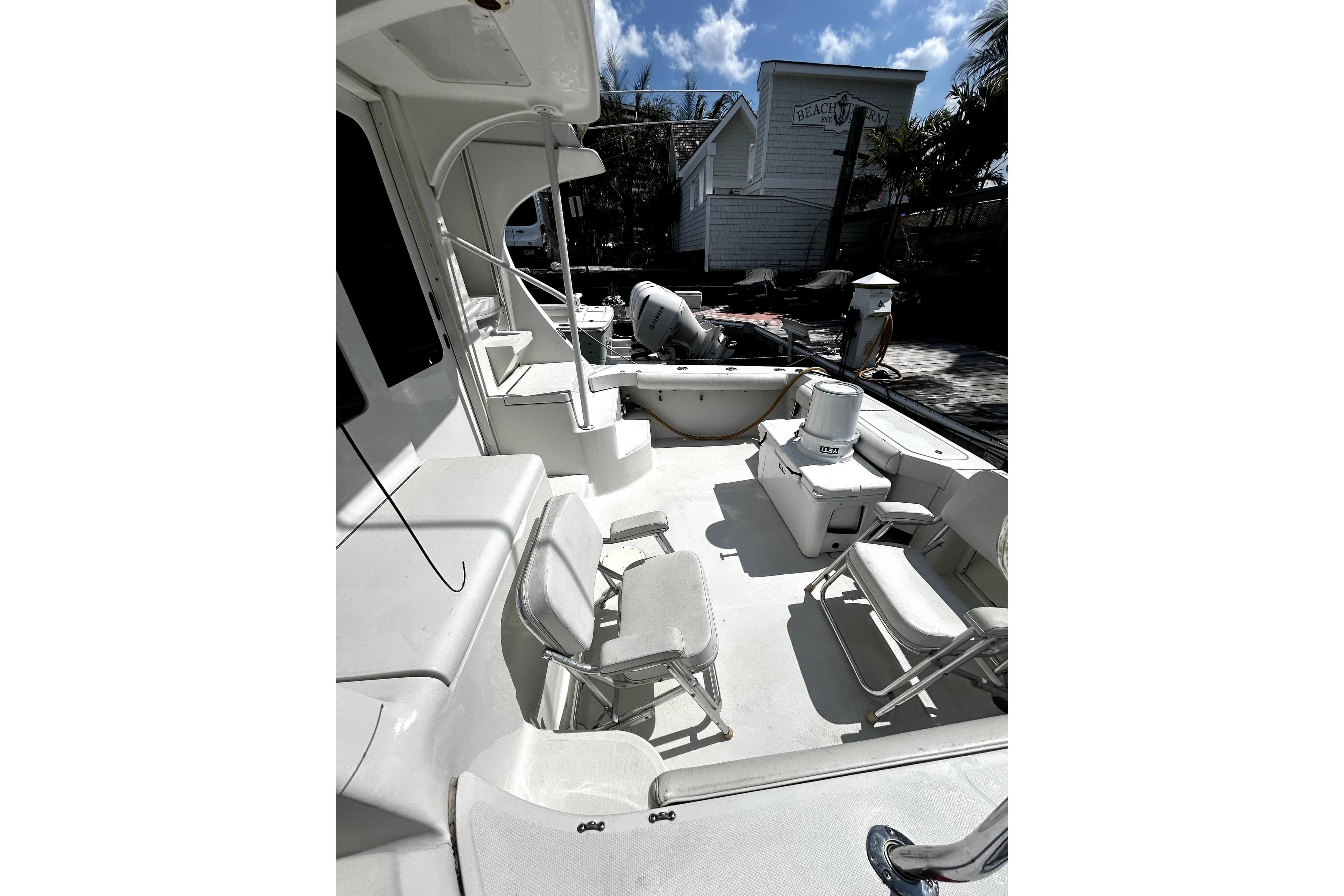 2001 Luhrs 34 Convertible boat deck with seating and equipment under sunny skies.