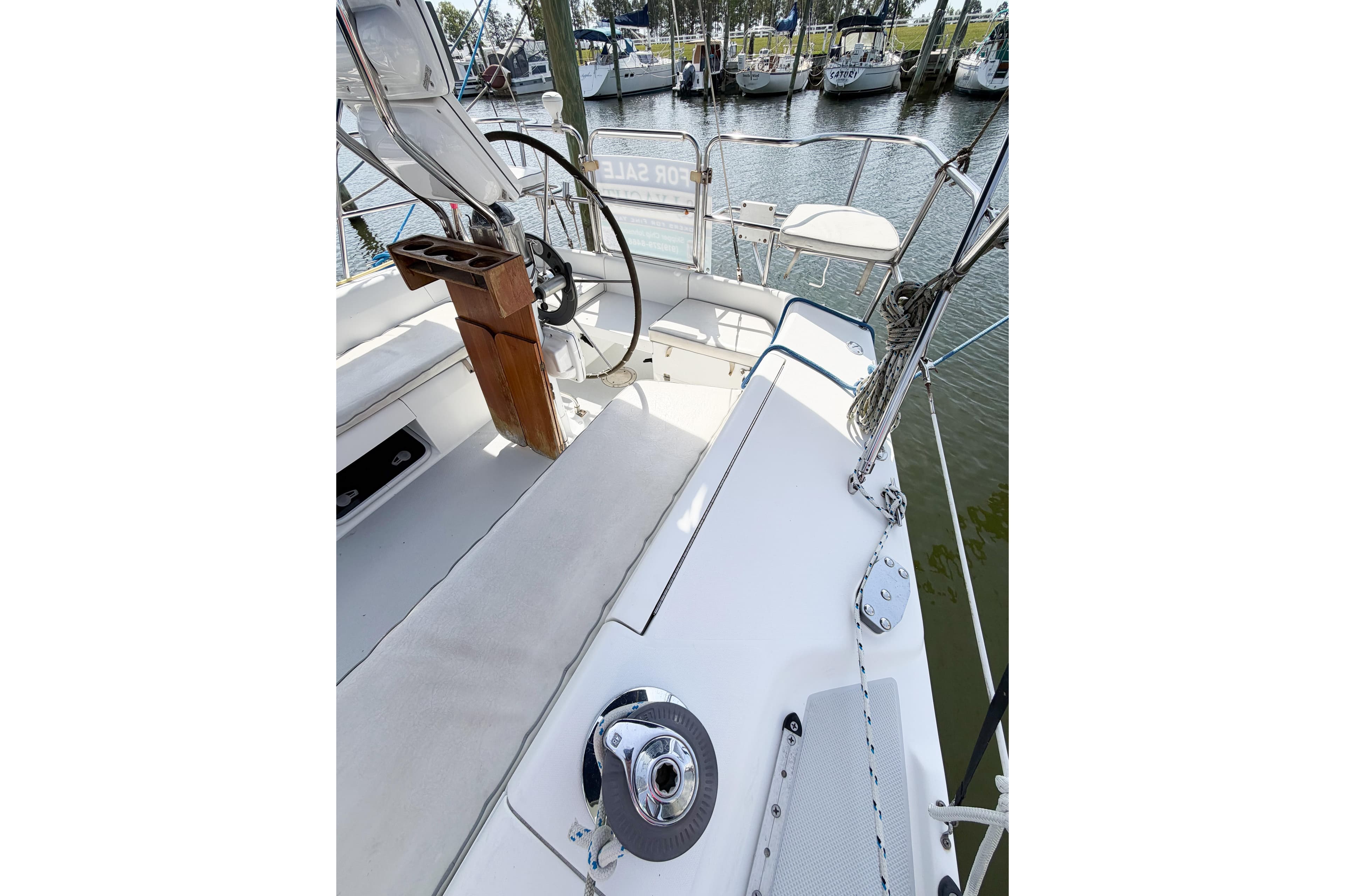 Cockpit view of 2003 Catalina 34 MkII sailboat, featuring steering wheel and seating area.