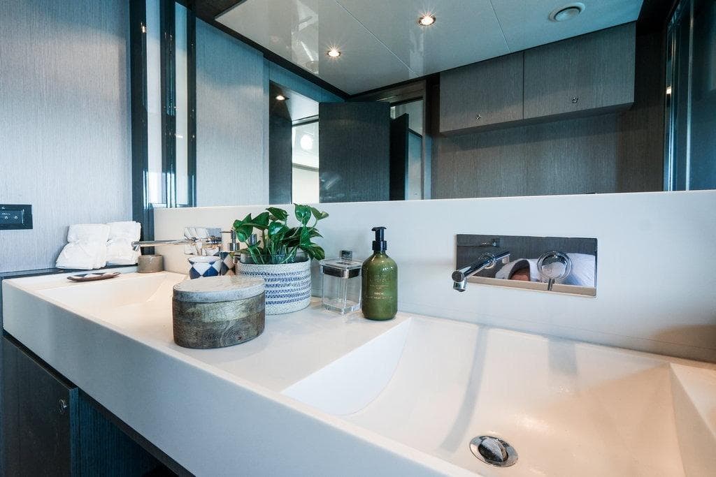 Luxurious bathroom on 2010 Riva 86' Domino yacht with modern sink and elegant decor.