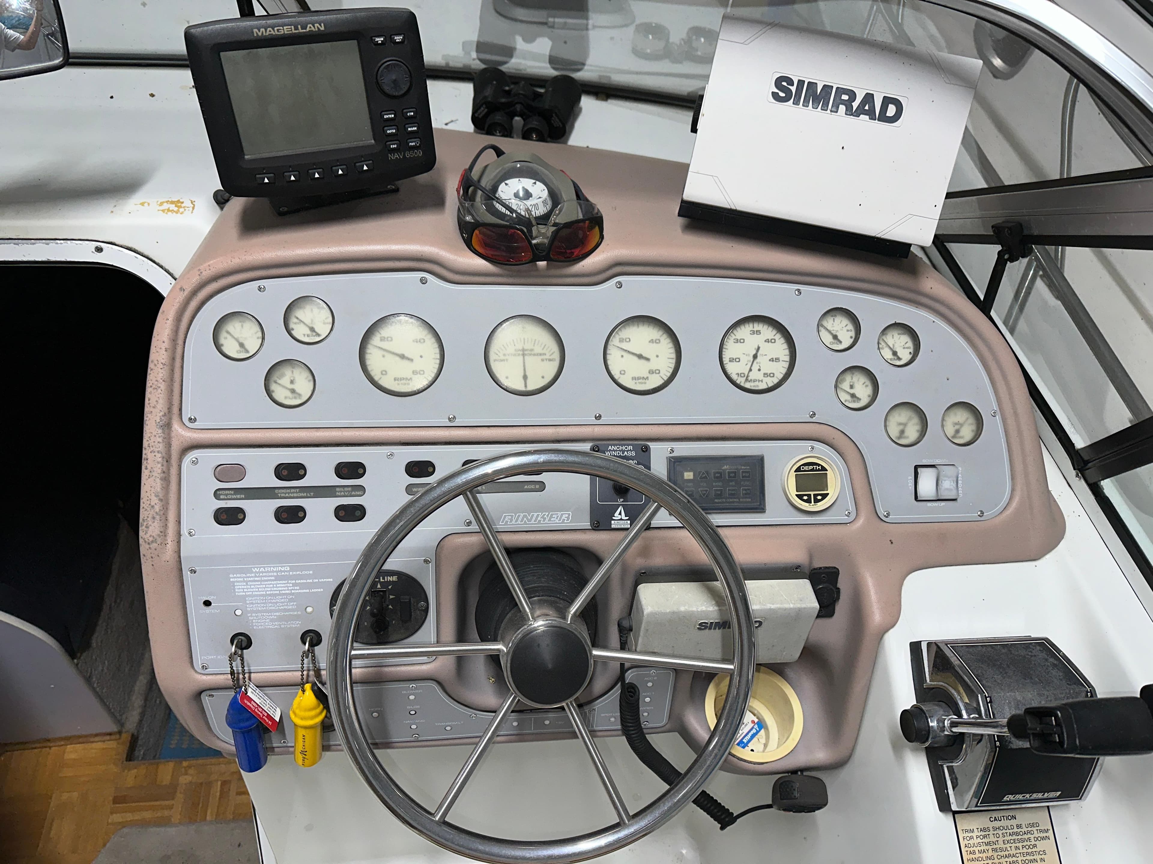 1993 Rinker 280 Fiesta Vee boat dashboard with steering wheel, gauges, and navigation equipment.
