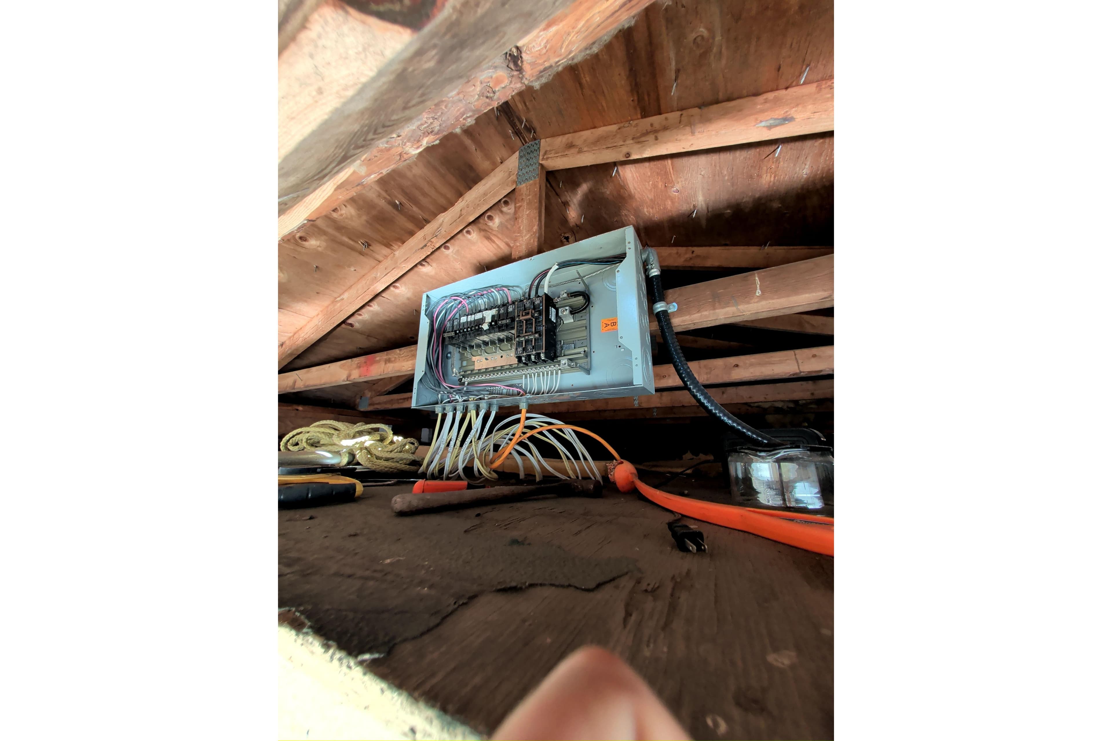 Electrical panel inside a 1979 custom houseboat liveaboard, with visible wiring and tools.