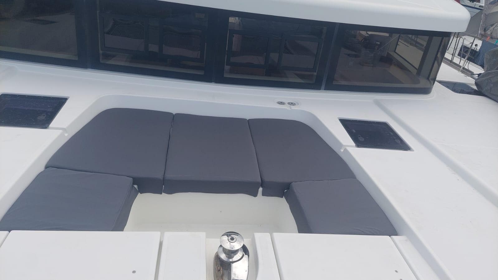 2016 Lagoon 52 yacht with cushioned deck seating and sleek design.