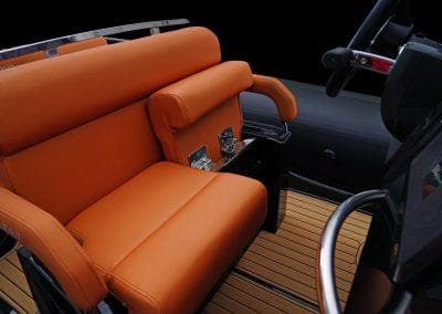 2025 Brig Eagle 6.7 PVC boat with orange seating and sleek steering wheel.