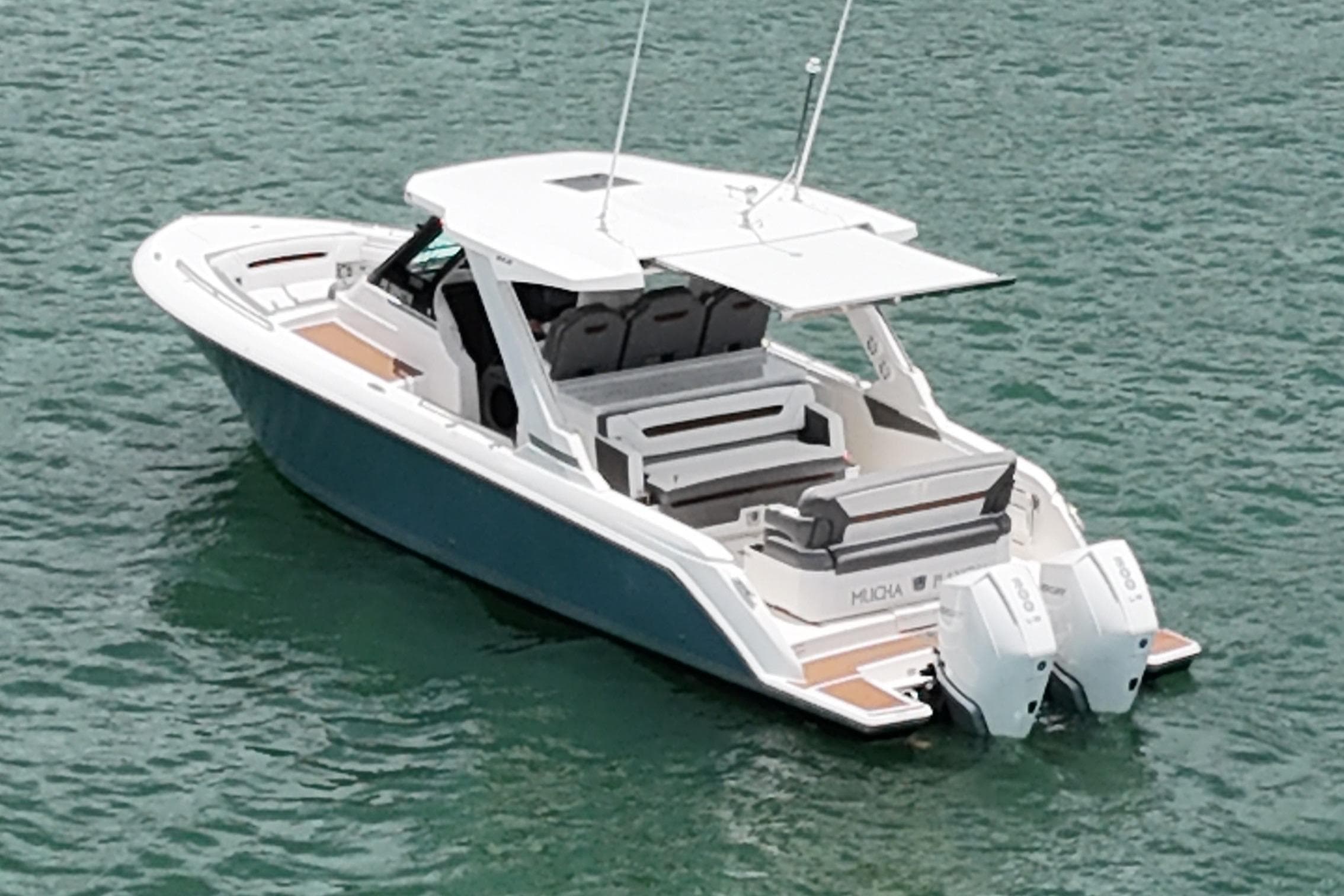2020 Tiara Sport 34 LS boat on water, featuring dual outboard engines.