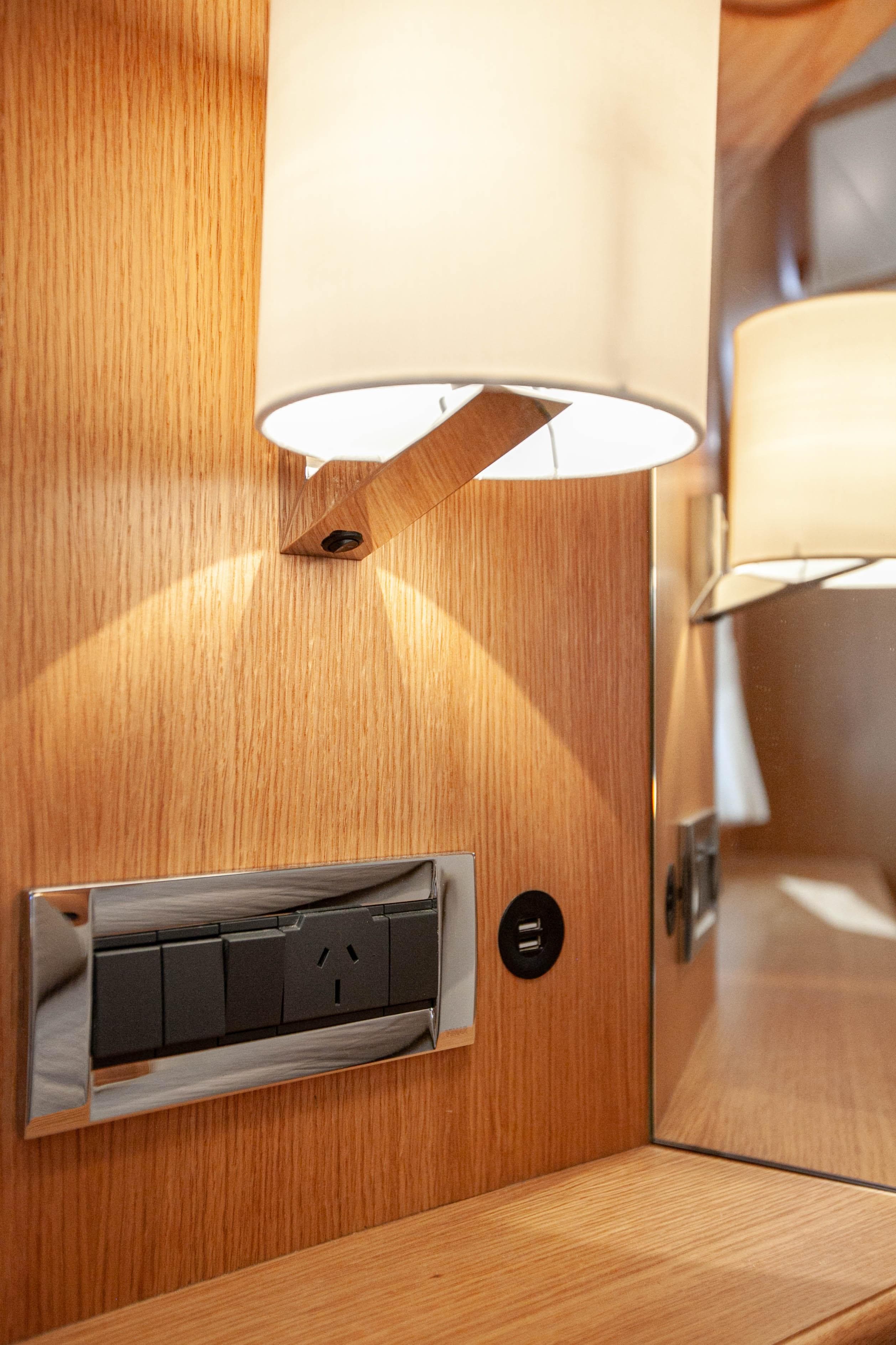 Modern interior of 2023 Vicem 55 yacht with elegant lighting and power outlets.