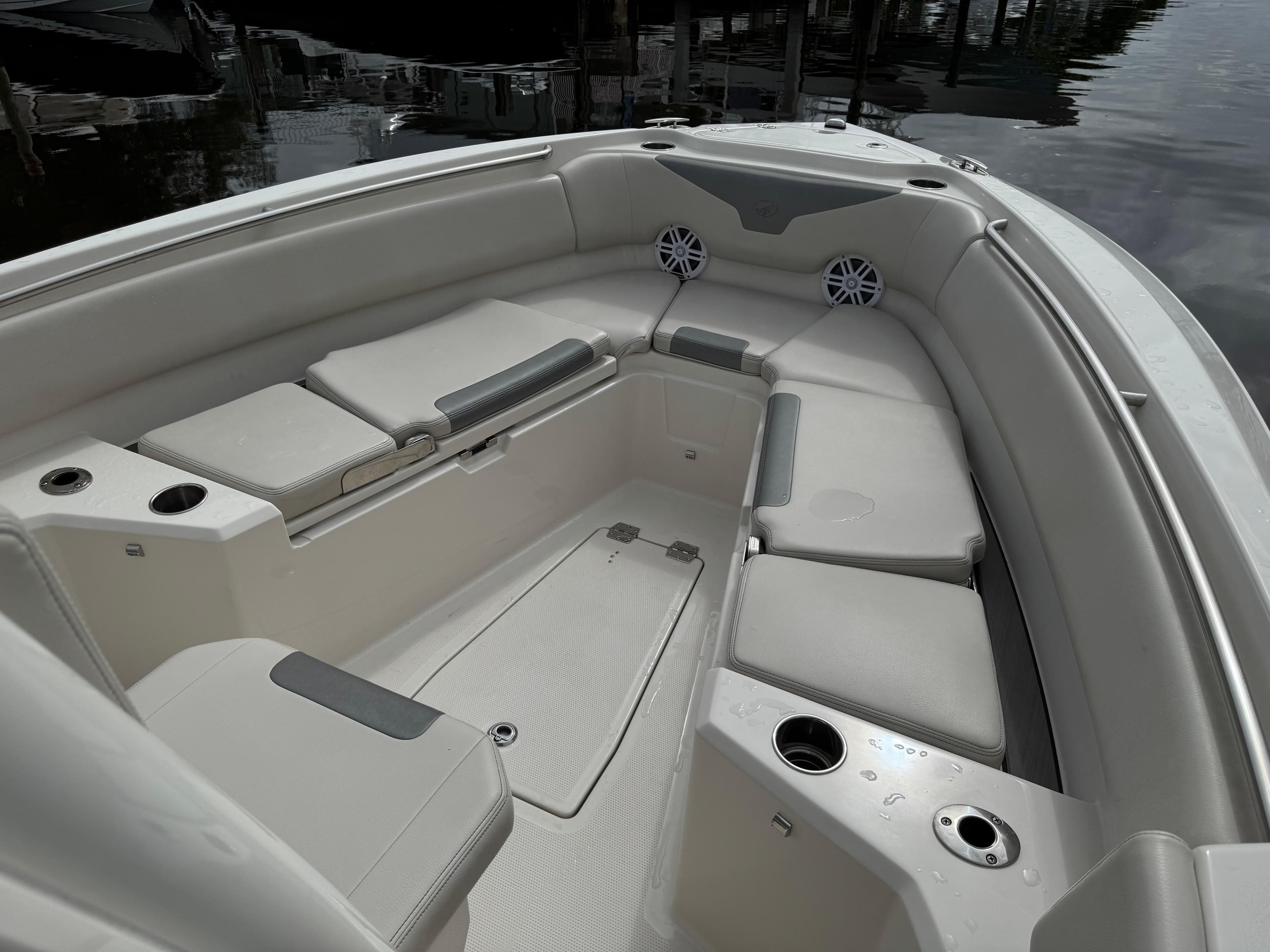 2025 Sailfish 232 CC boat interior with cushioned seating and cup holders.