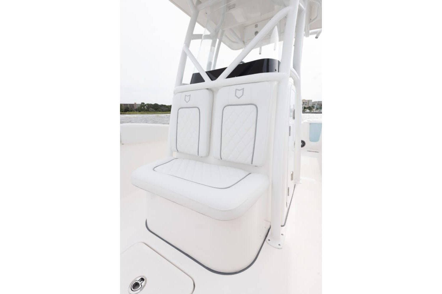 Manufacturer Provided Image: 2025 Sea Fox 248 Commander boat seating, white cushioned bench with backrest.