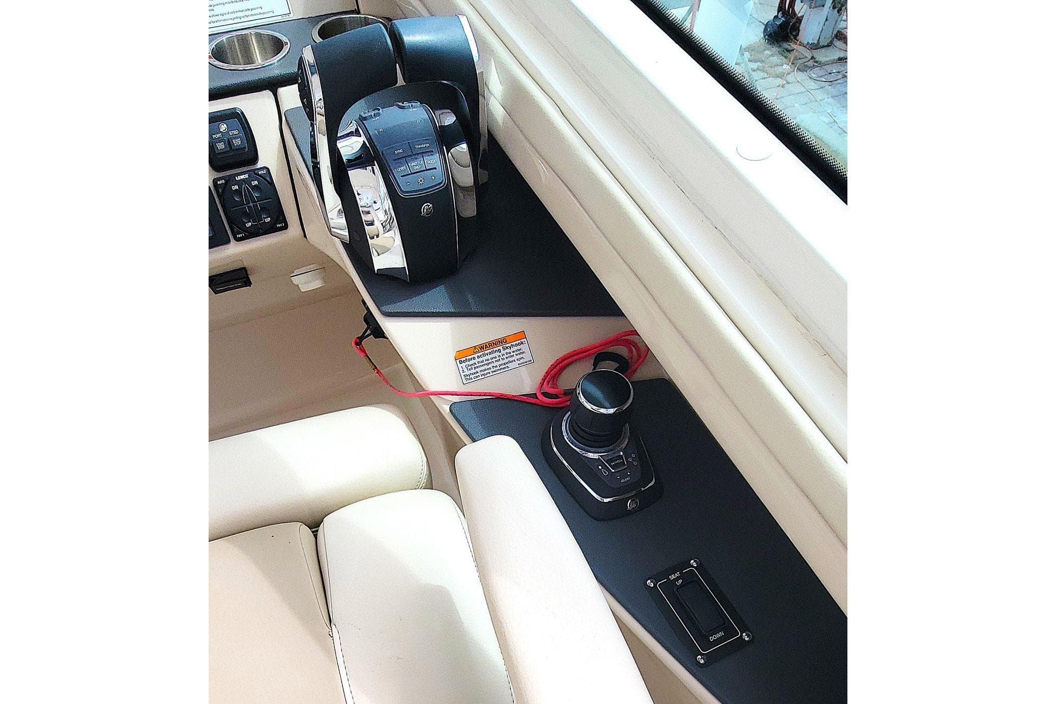 Control panel of a 2022 Boston Whaler 320 Vantage boat, featuring throttle and joystick.