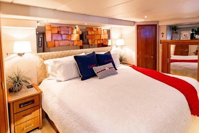 Luxurious bedroom in 2000 Pacific Mariner 65 Motoryacht with elegant decor and cozy bedding.