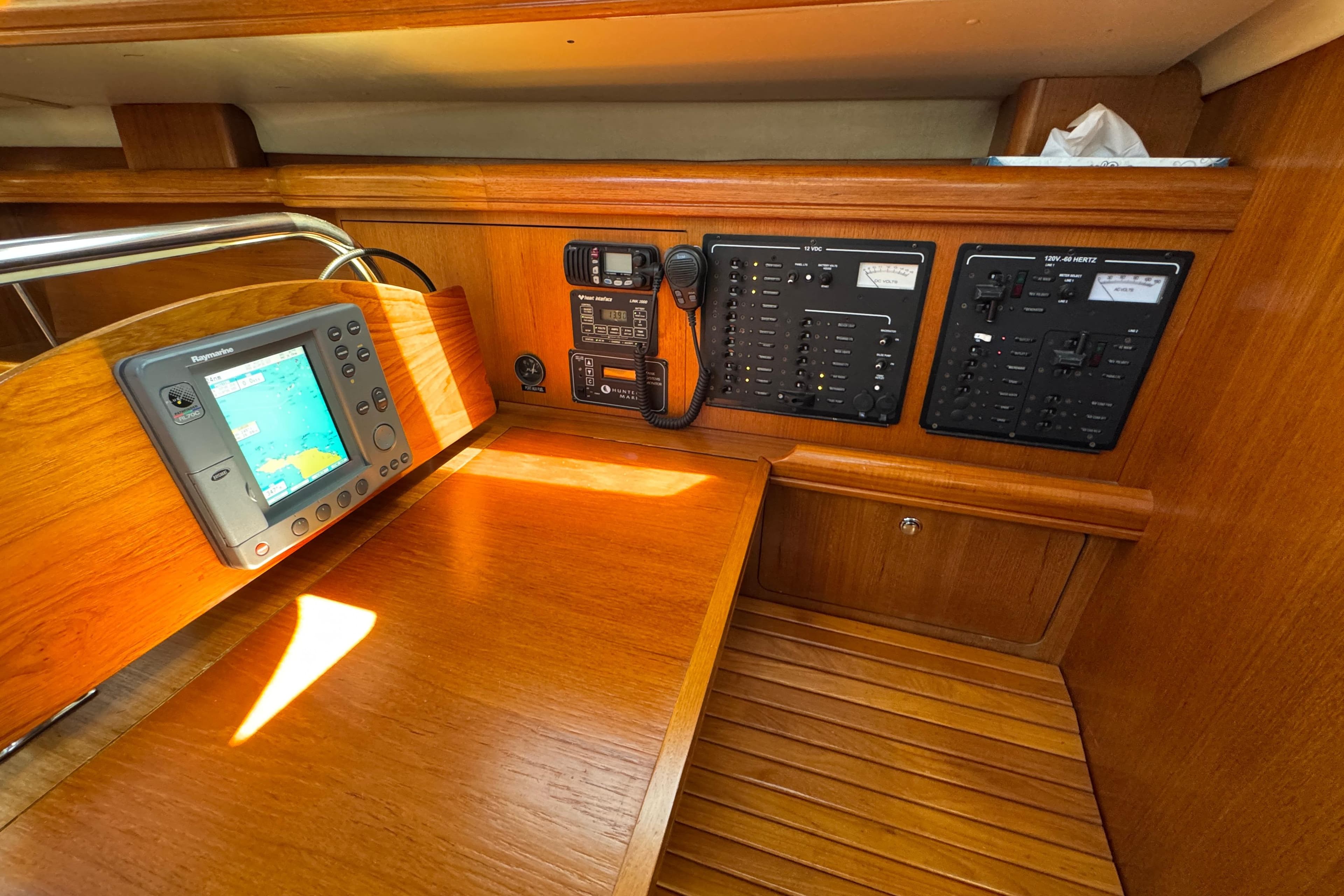 Navigation station of 2004 Hunter 41 Aft Cockpit yacht with control panels and GPS.
