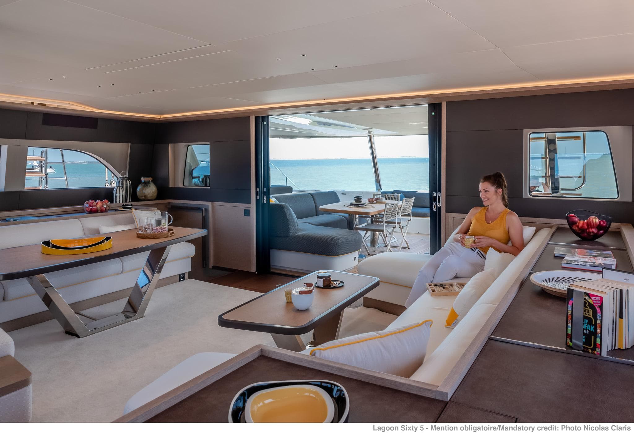 Luxurious interior of 2025 Lagoon SIXTY 5 yacht with modern furnishings and ocean view.