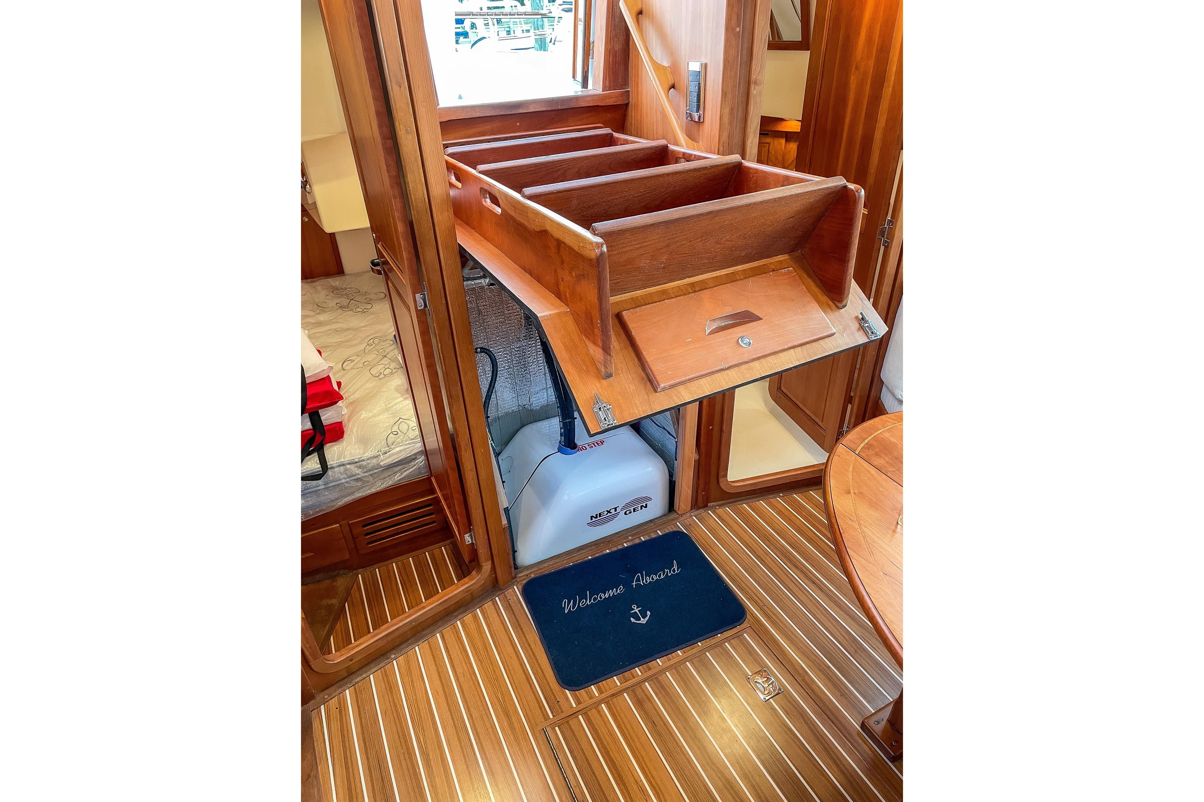 Interior of 2007 Tartan 4400 yacht with wooden stairs and nautical decor.