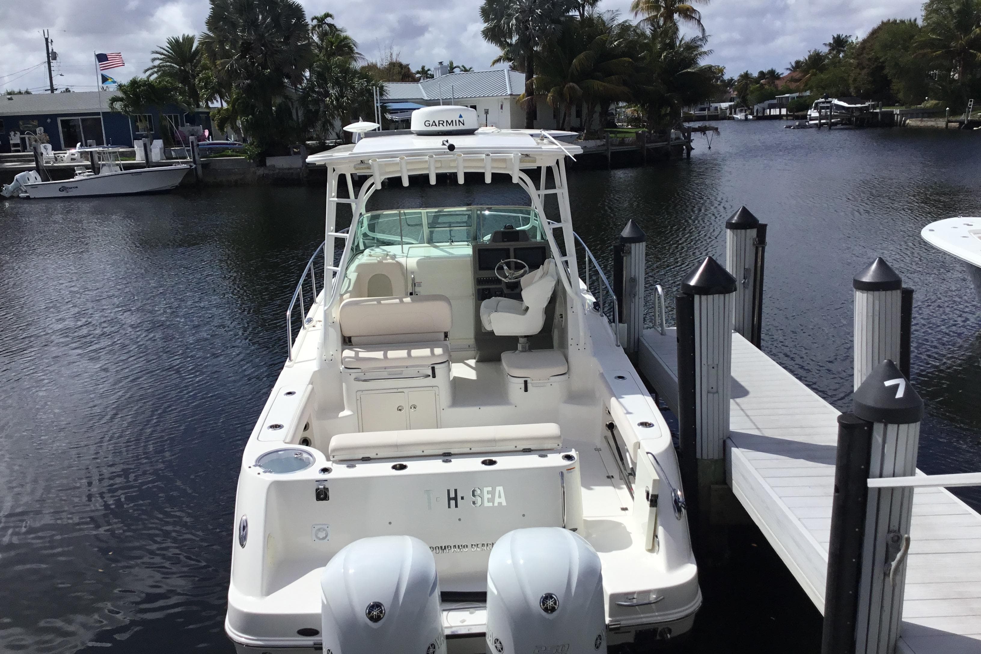 2017 Robalo R305 Walkaround boat docked at marina with twin engines.