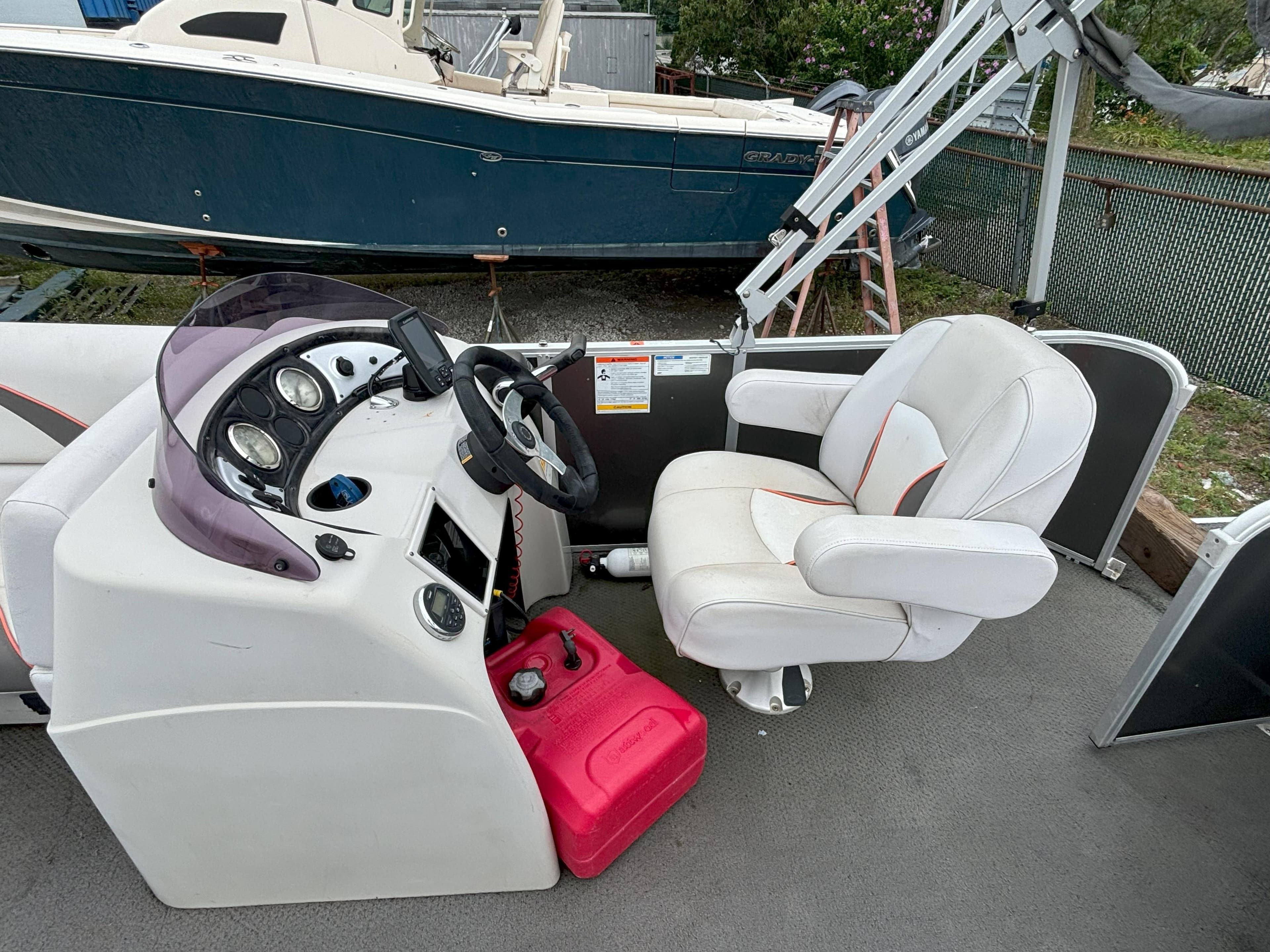 2018 SunCatcher V16 Cruise boat interior with steering console and captain's chair.