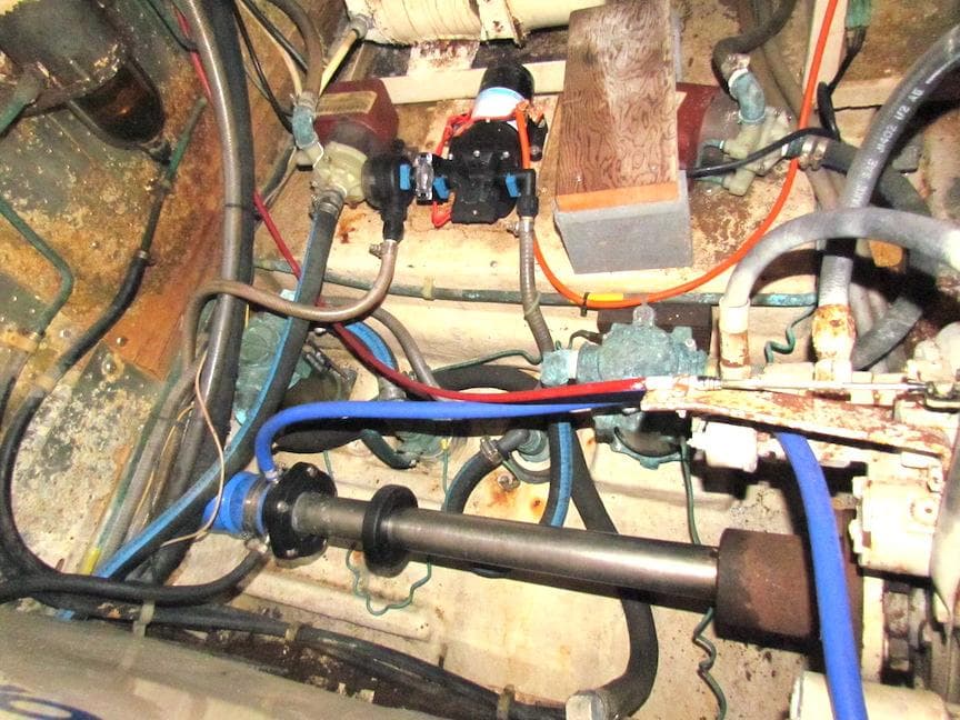 Engine room of a 1997 Hyatt 55 yacht with visible pipes and machinery.