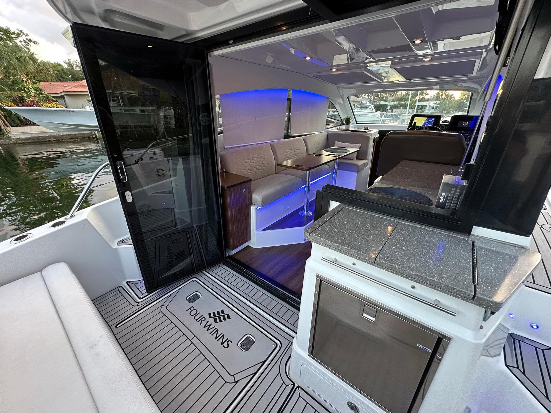 2020 Four Winns Vista 355 Coupe interior with modern seating and ambient lighting.