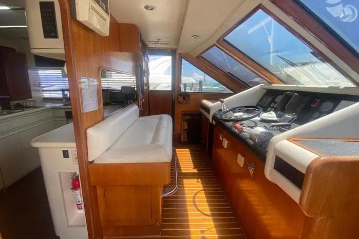 Interior of 1990 Viking Motor Yacht with wooden accents and navigation controls.