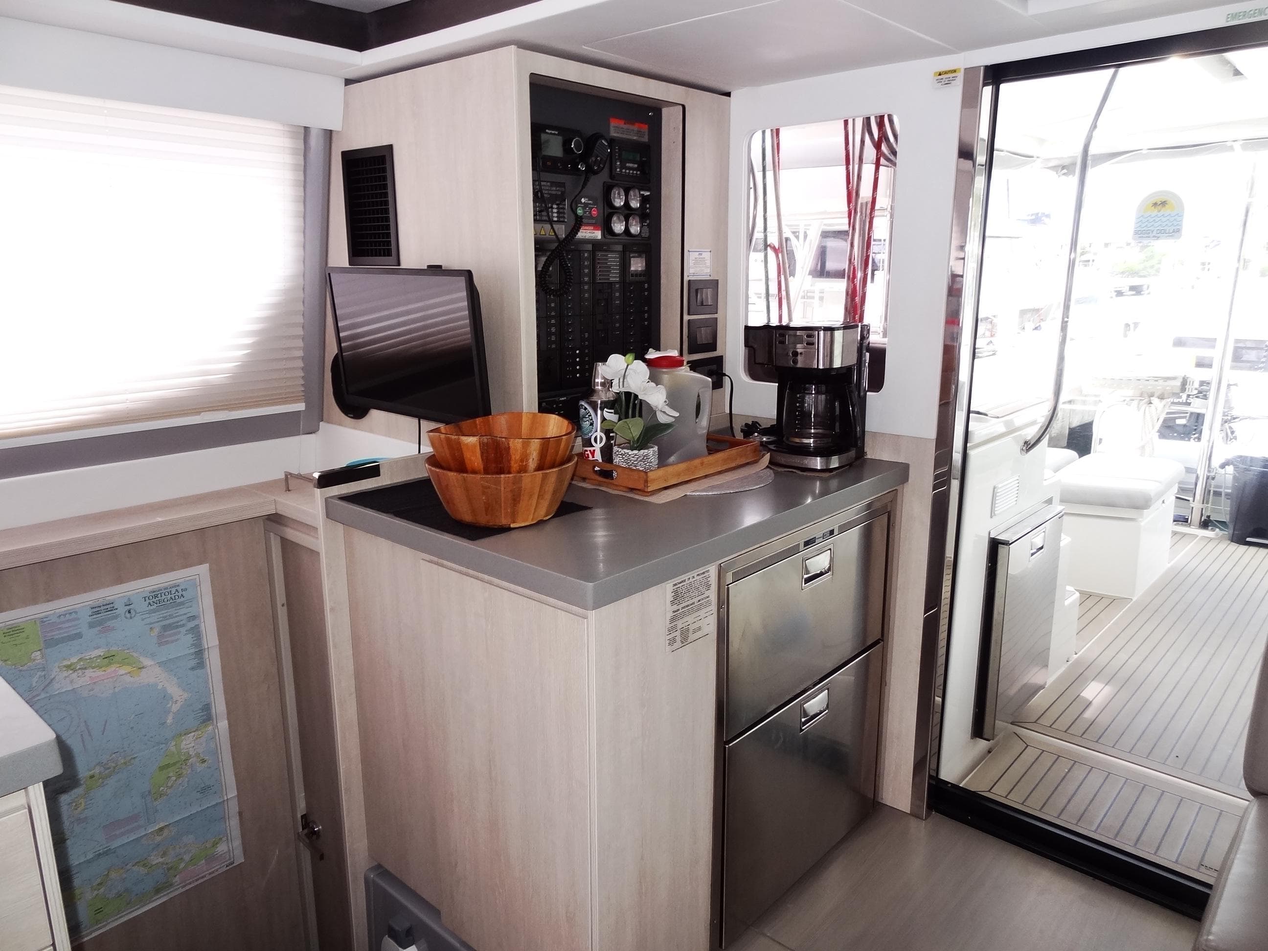 Modern kitchen area in a 2020 Leopard 45 catamaran, featuring appliances and navigation equipment.