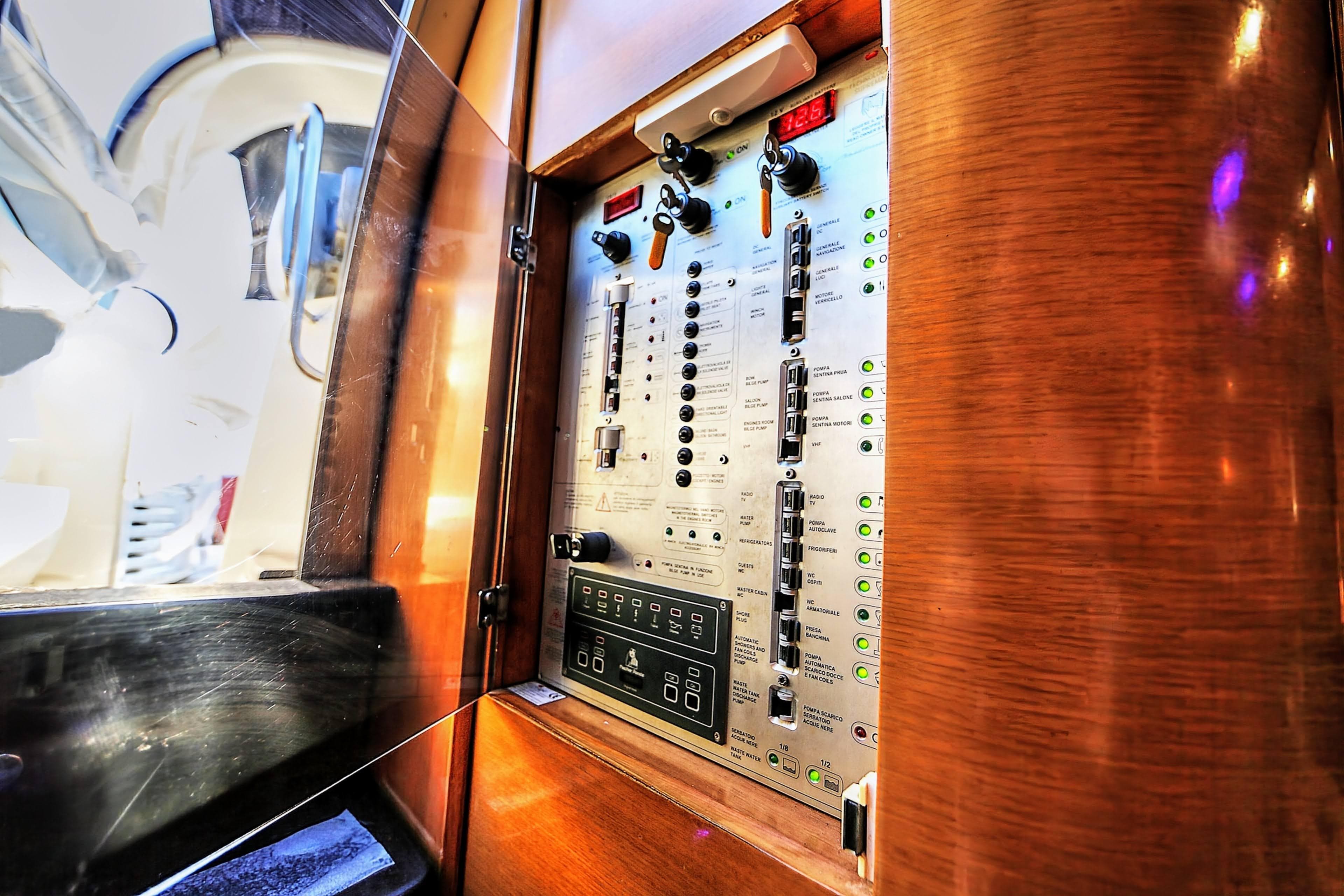 Control panel inside 2008 Cranchi Mediterranee 43 yacht, featuring switches and indicators.