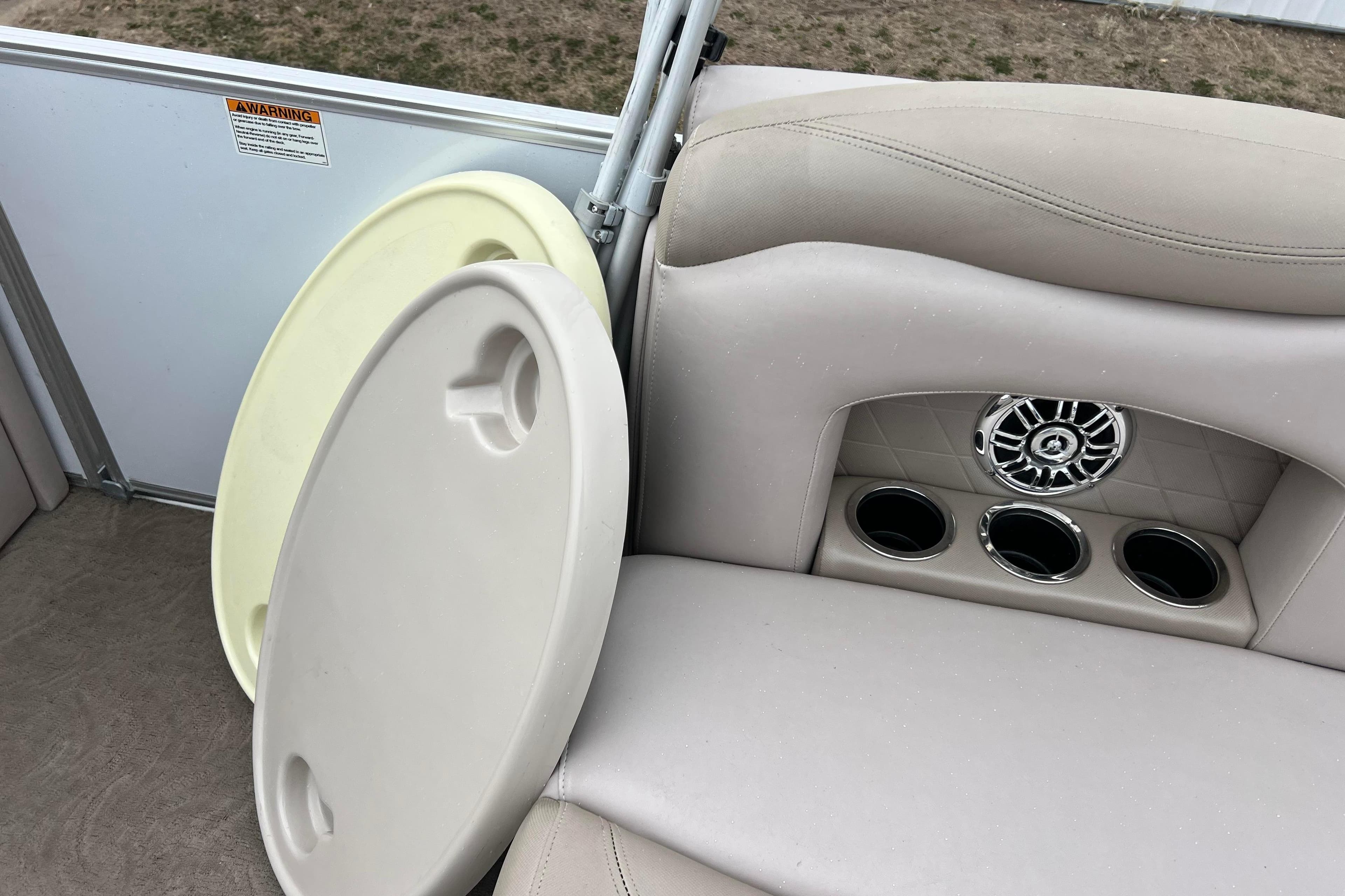 2014 Sylvan Mirage Cruise 8520 CR boat interior with cup holders and speaker.