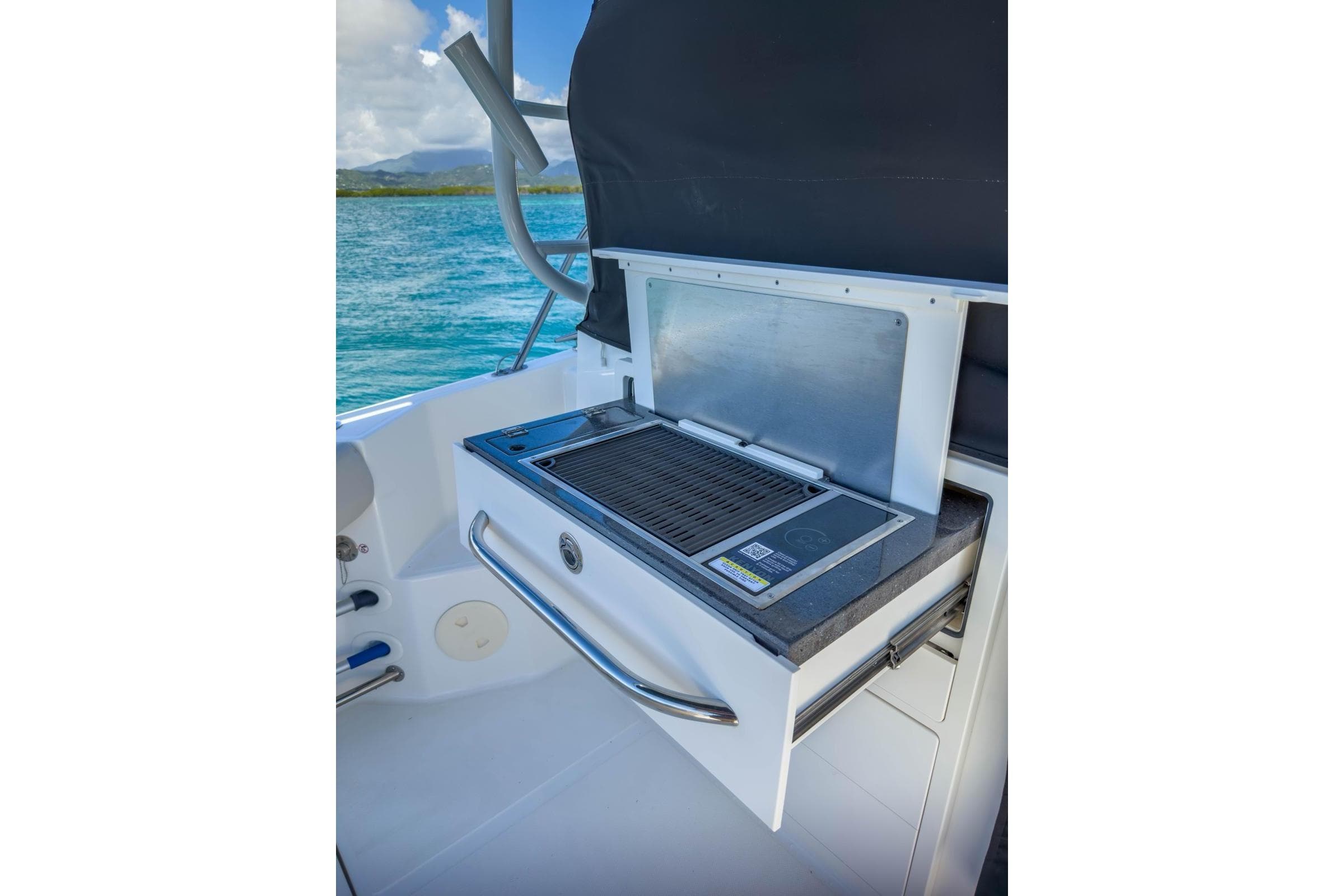 2024 Boston Whaler 325 Conquest onboard grill with ocean view.